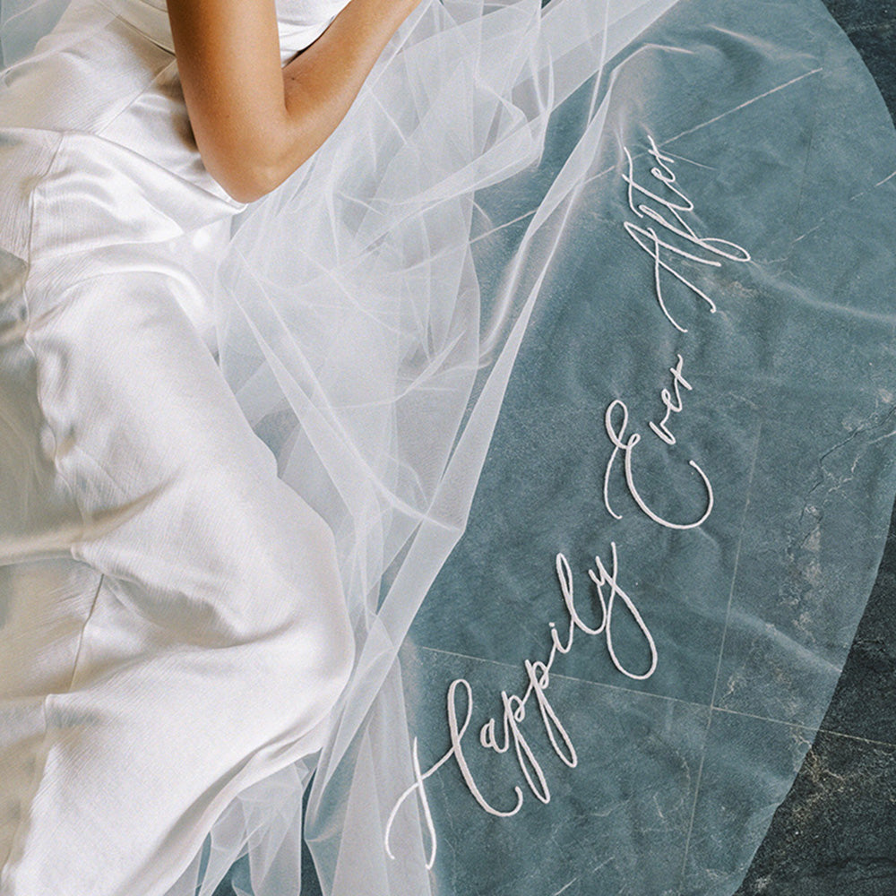 Romantic message embroidered in script font on train of wedding veil by Madame Tulle bridal