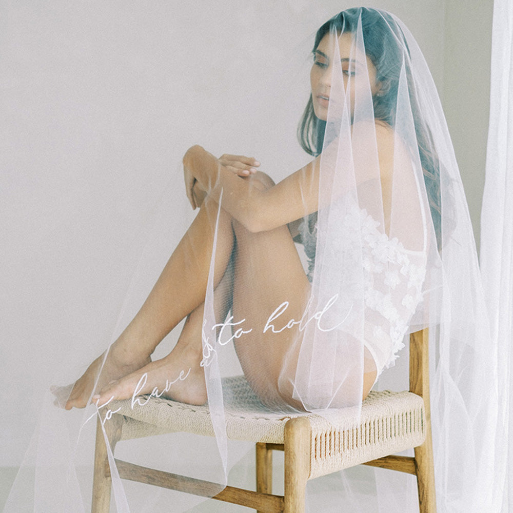 Bride models drop veil custom embroidered with romantic message