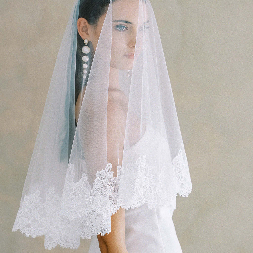 Bride models mini drop veil trimmed with romantic lace