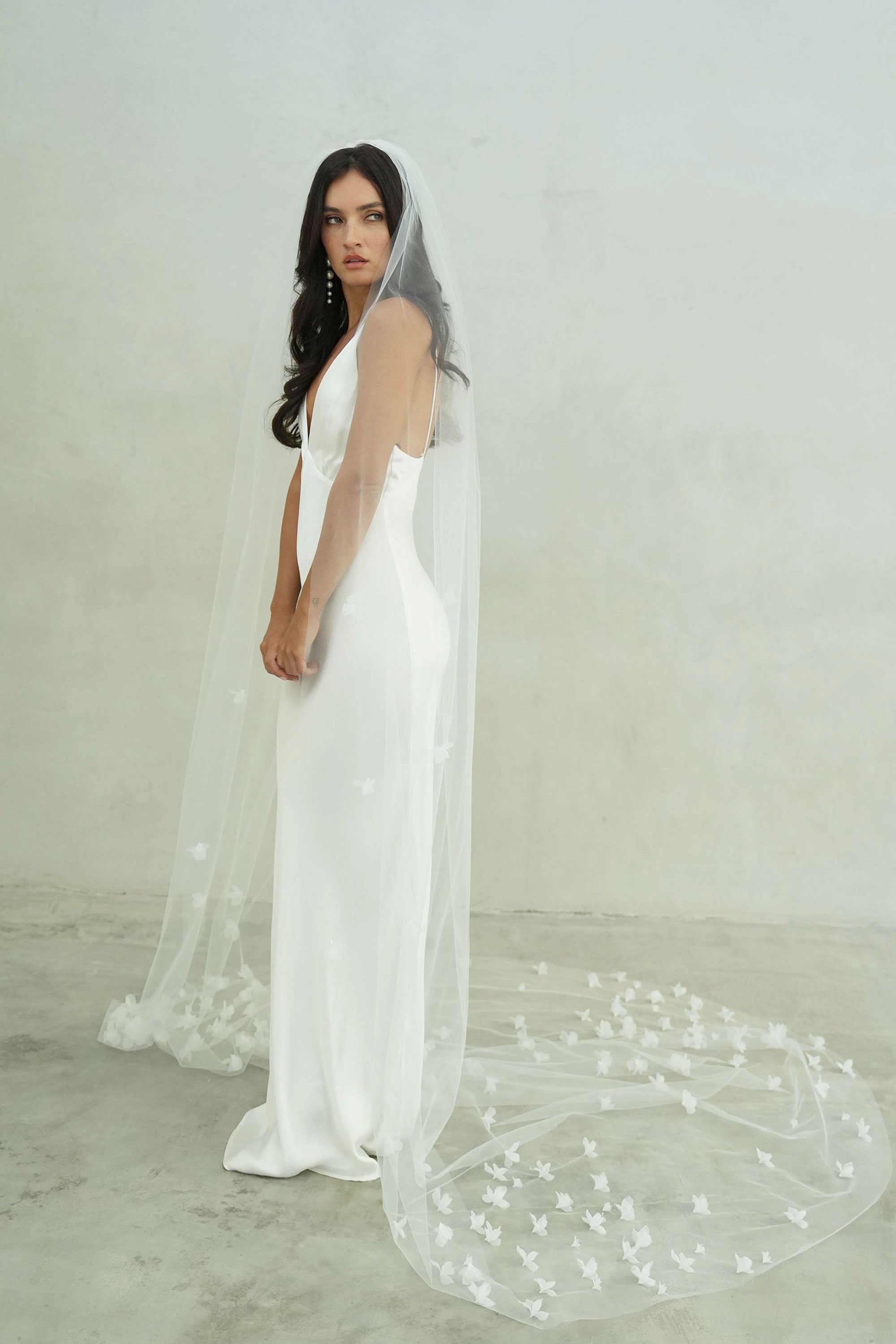 model wears a one-tier small-medium size flowers wedding veil, floral veil