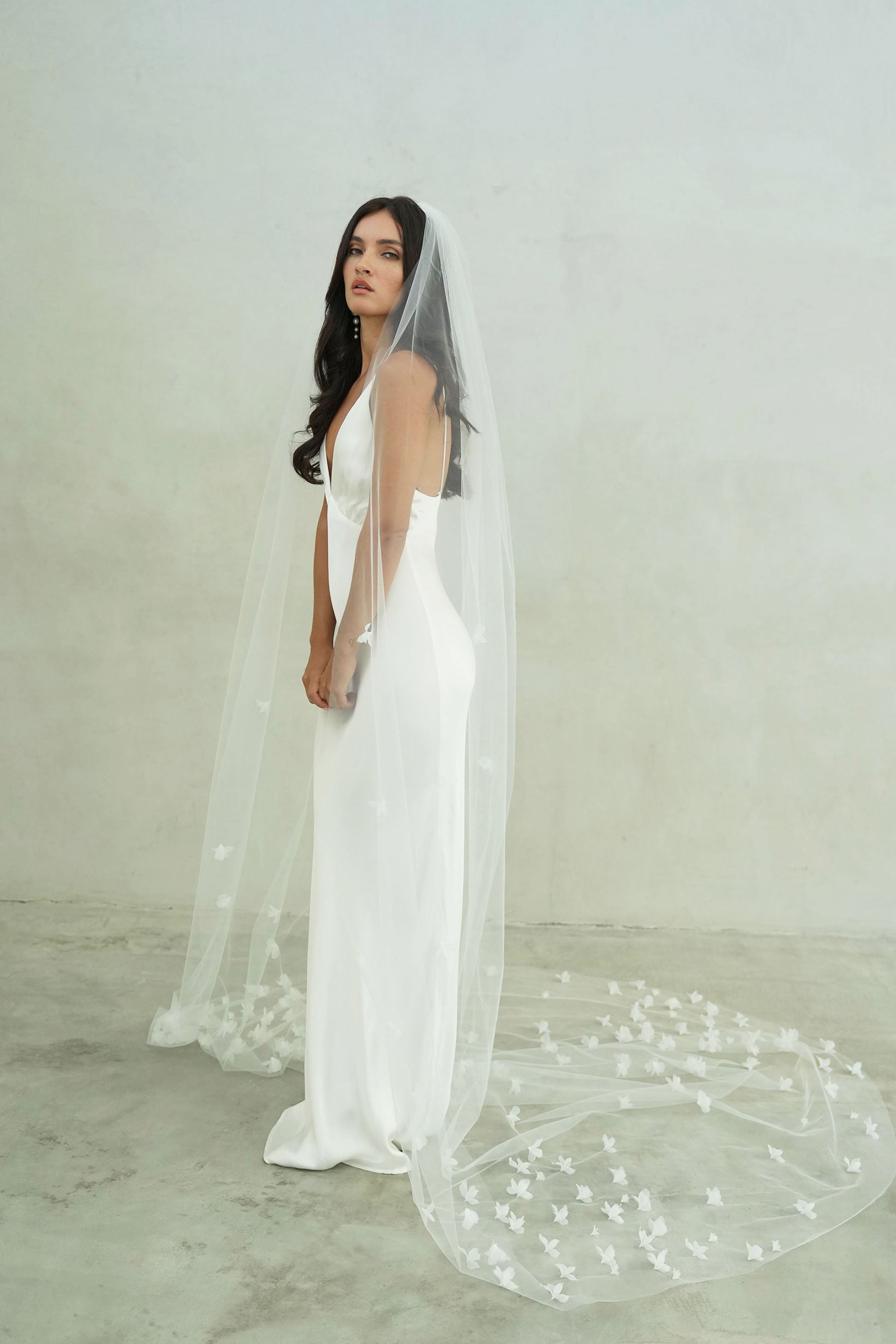 model wears a one-tier small-medium size flowers wedding veil, floral veil