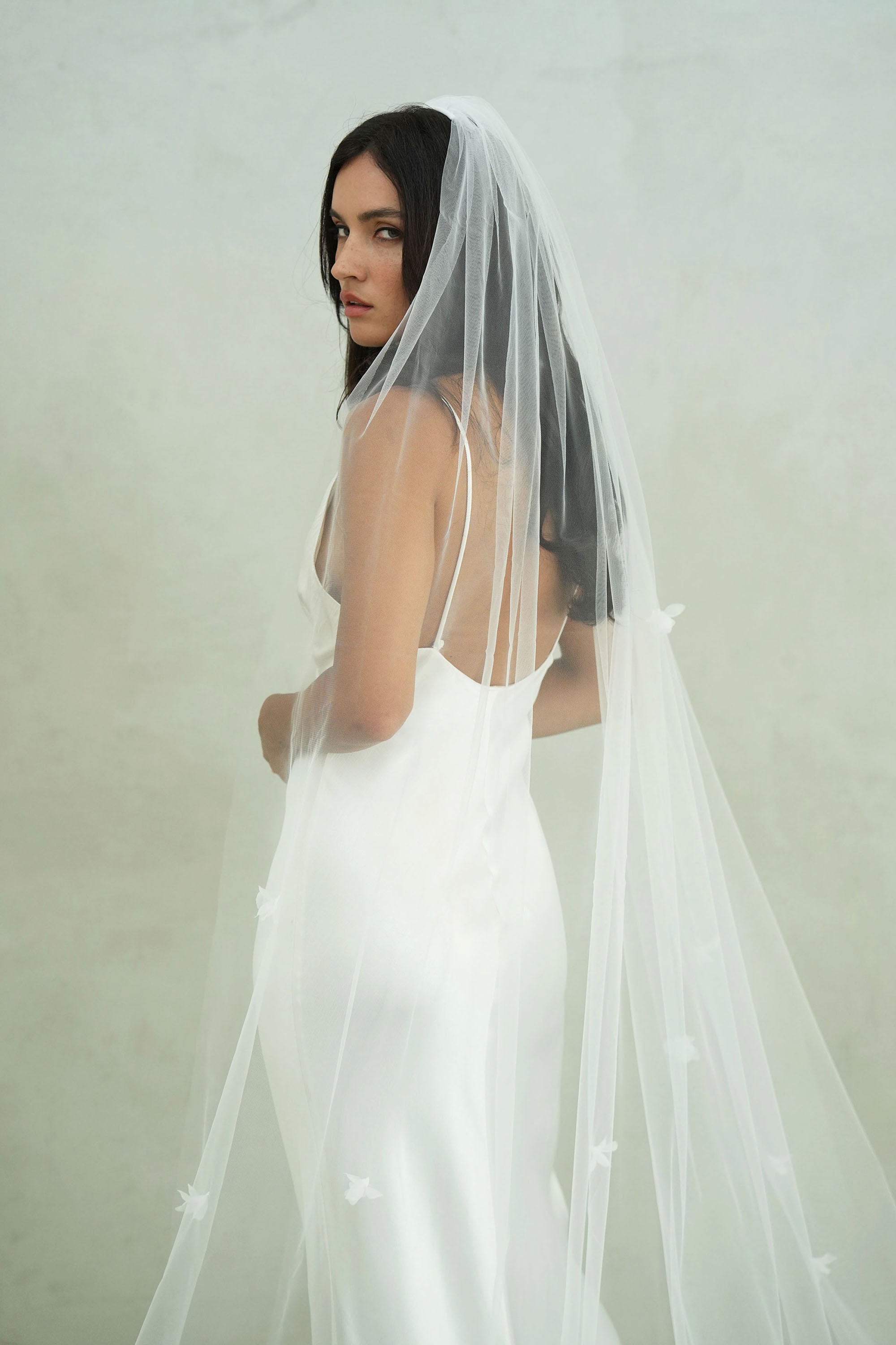model wears a one-tier small-medium size flowers wedding veil, floral veil
