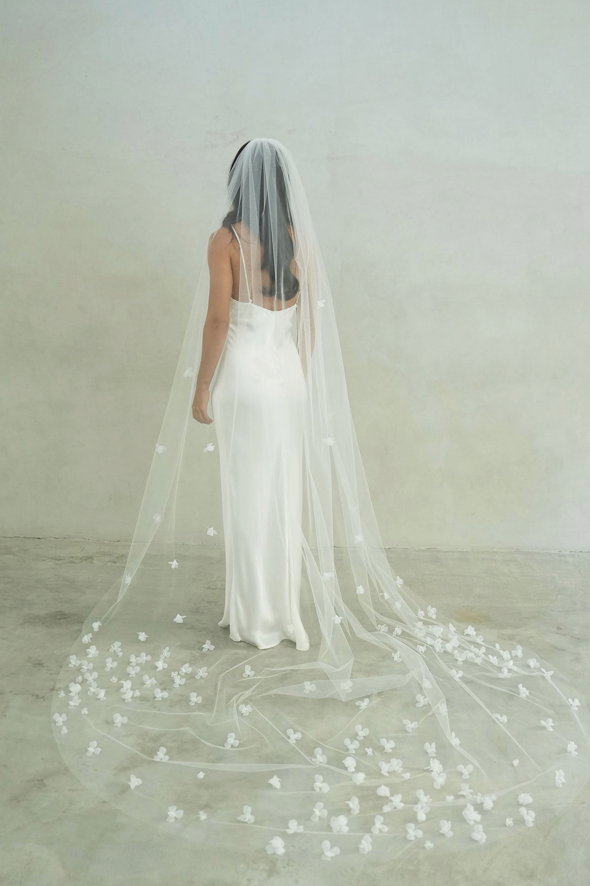 model wears a one-tier small-medium size flowers wedding veil, floral veil