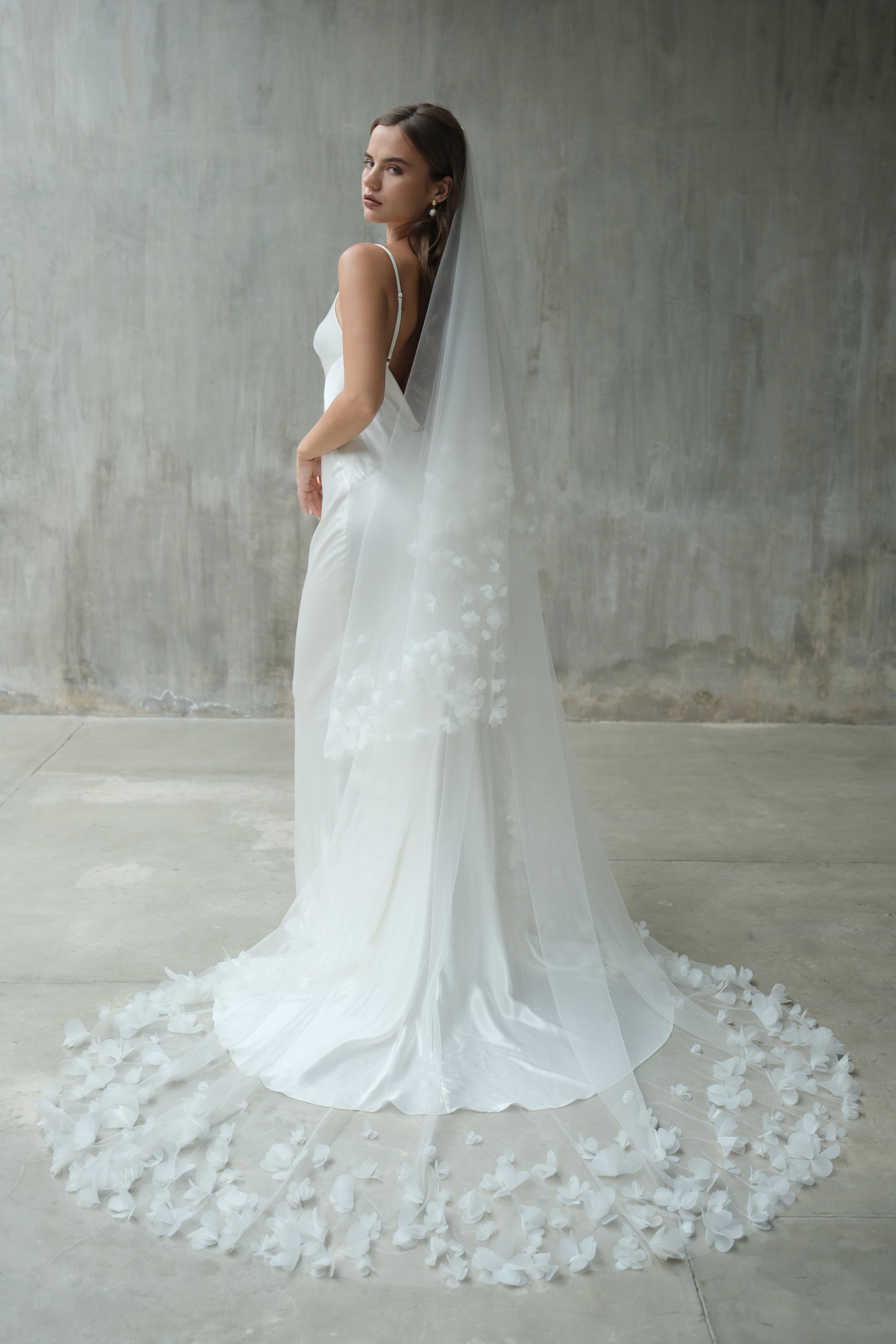 Back view of long bridal veil edged with fabric flowers