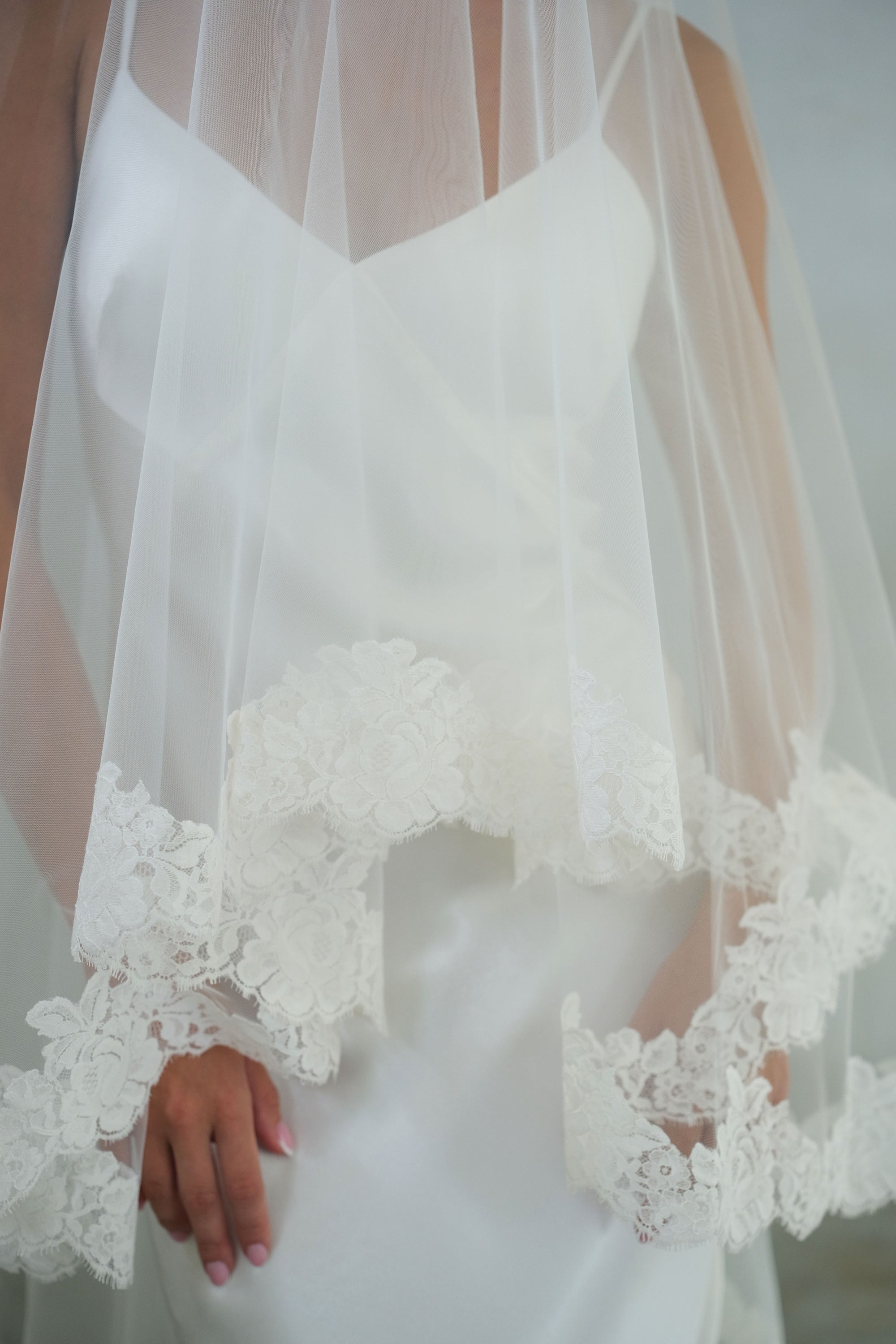 Lace detail on blusher edge of two-tiered bridal veil