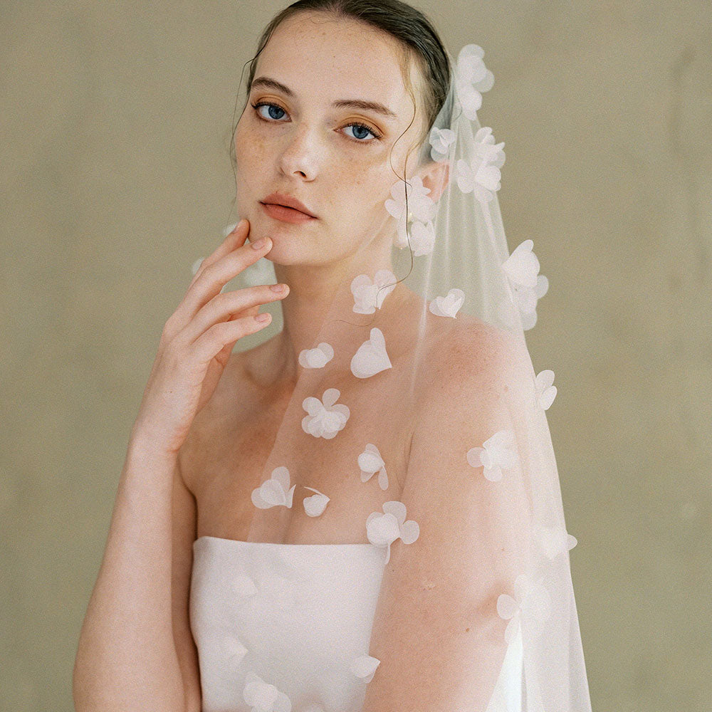 Bride models one tier wedding veil scattered with fabric flowers