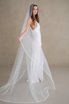 Model wears a pearl wedding veil, one tier veil with pearls.