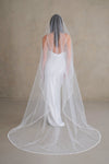 Model wears a pearl wedding veil, one tier veil with pearls.