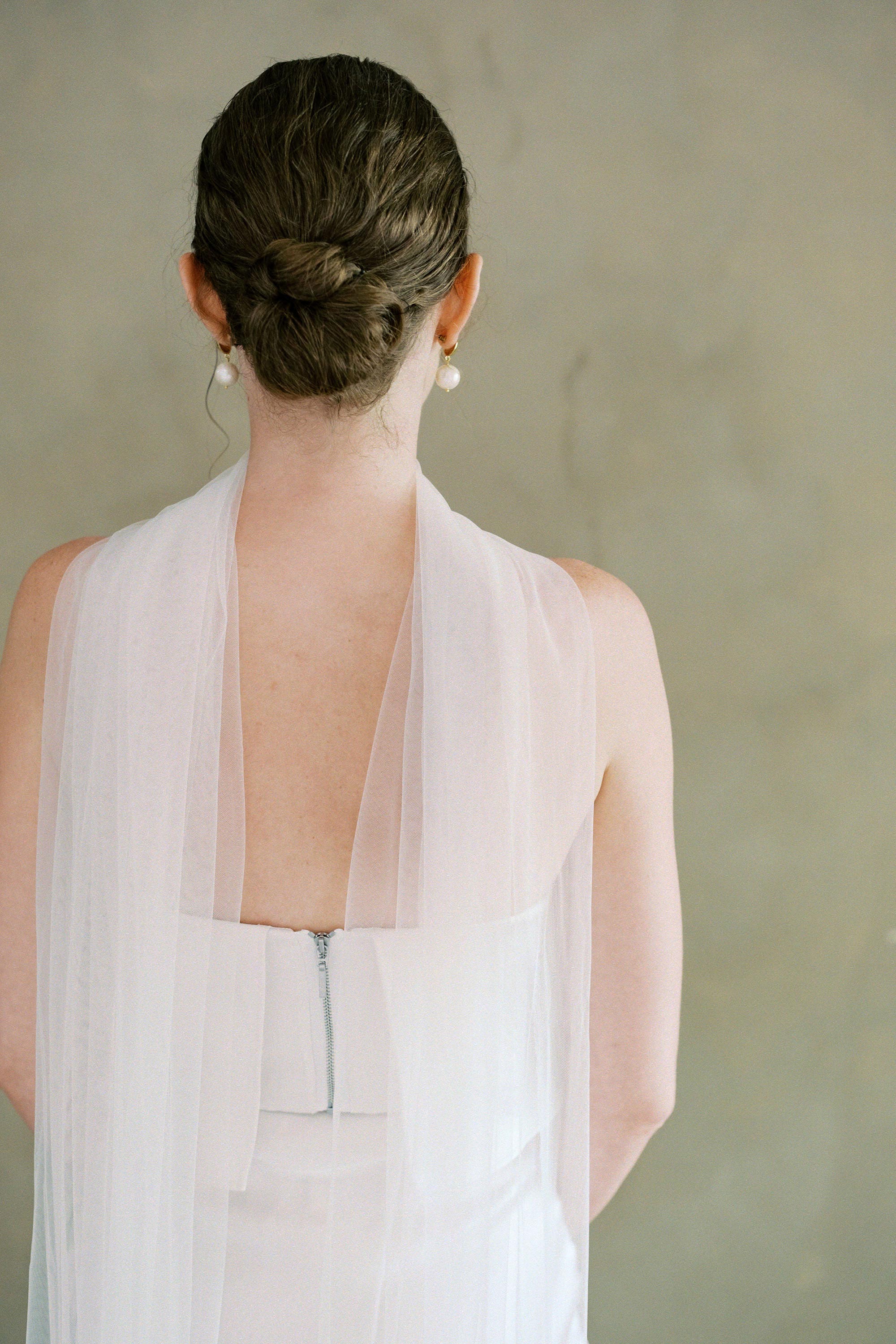 model wears soft tule wedding scarf 