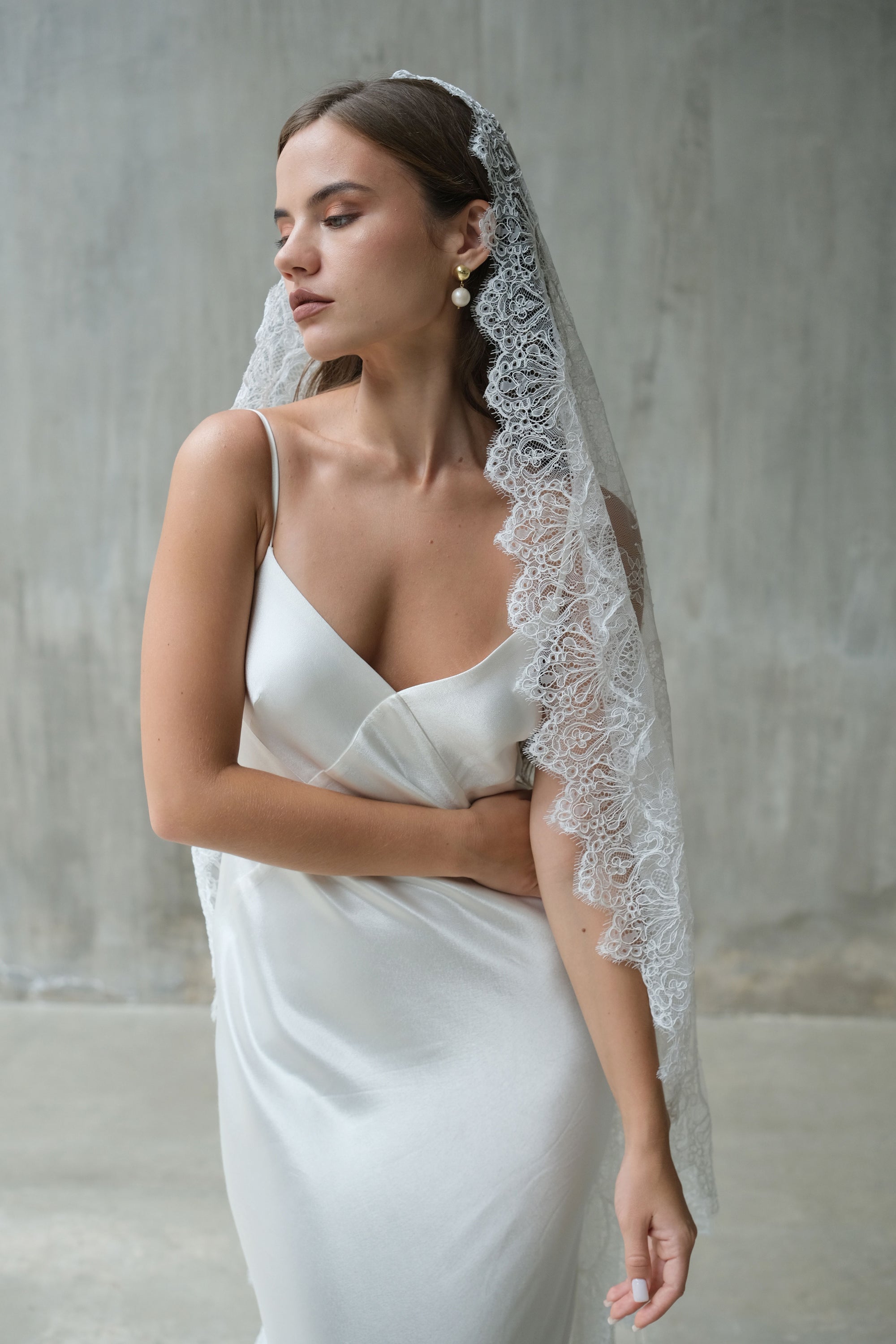 Lace scallop-edged, full lace mantilla bridal veil complements minimalist styling of front-facing bride
