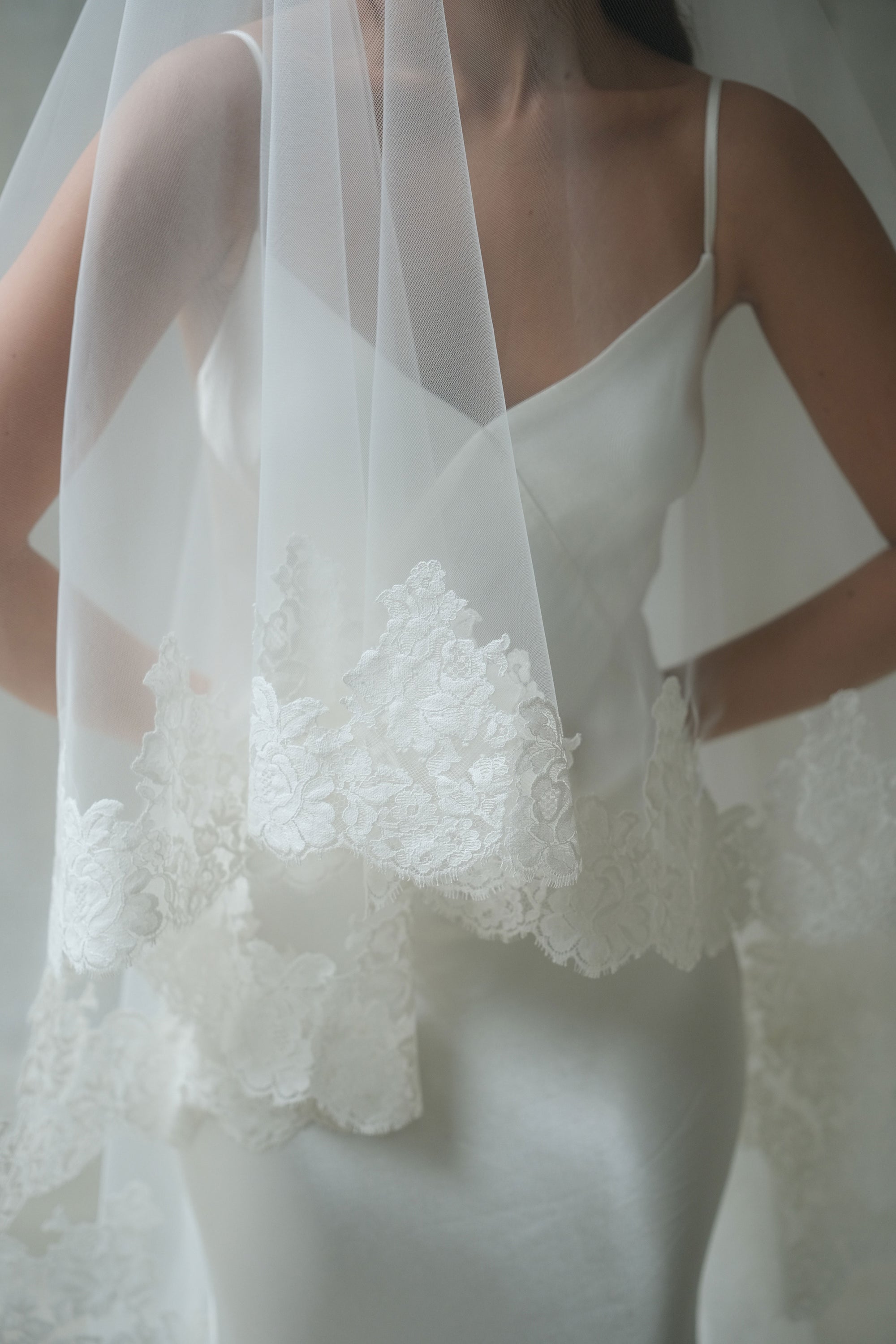 Detailed lace edge on blusher of long two tier wedding veil