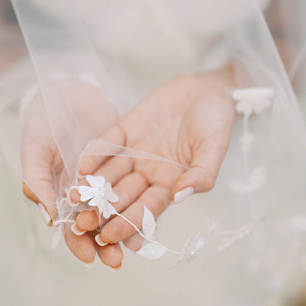 Close up of embroidered and beaded floral detail on handcrafted bridal veil by Madame Tulle
