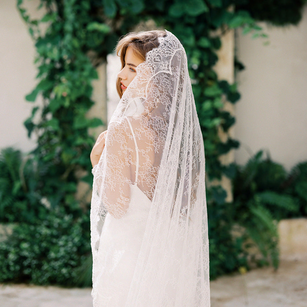 Bride models full lace wedding veil worn mantilla style