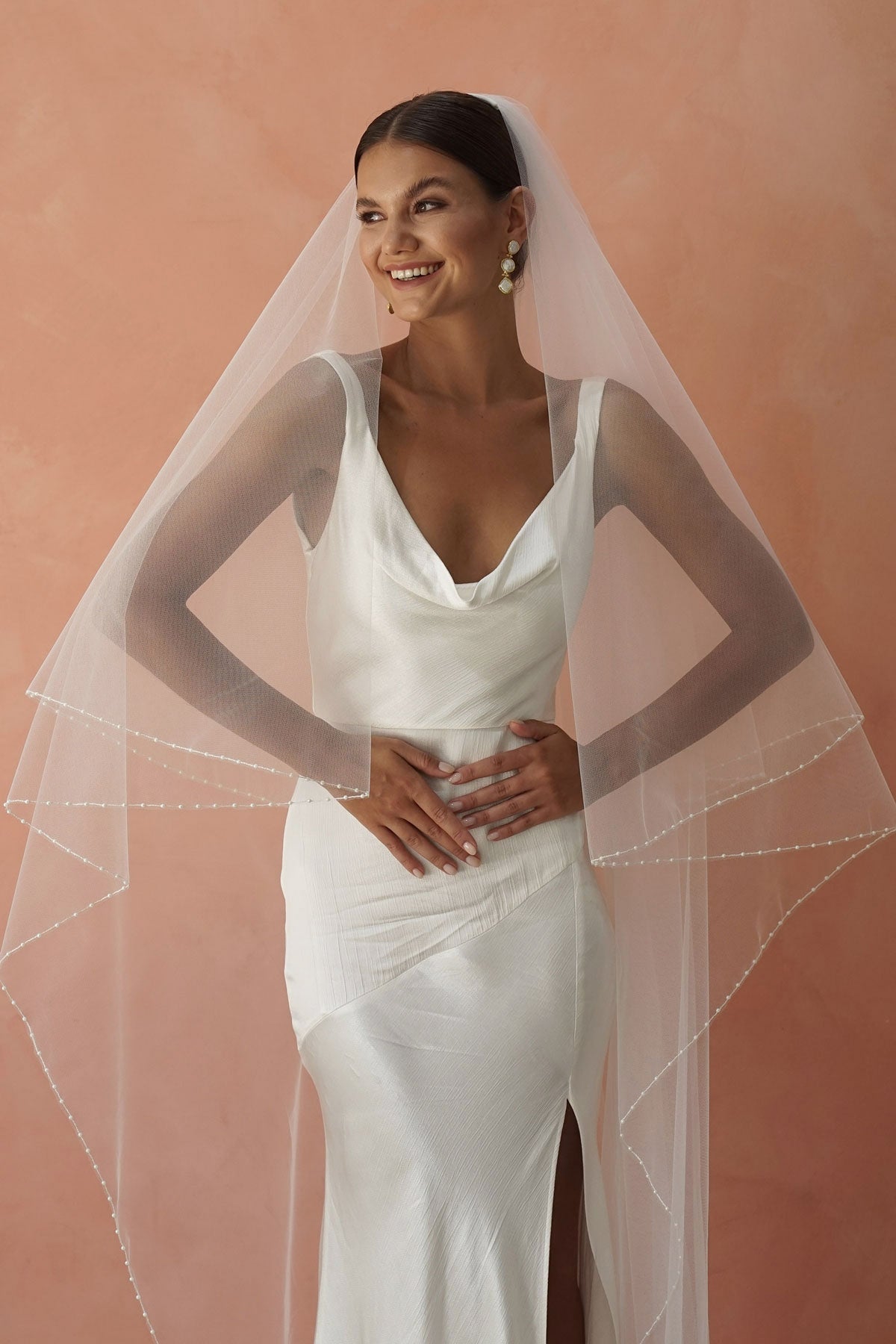 model wears two-tier pearl edge veil, drop veil with pearls on the edges