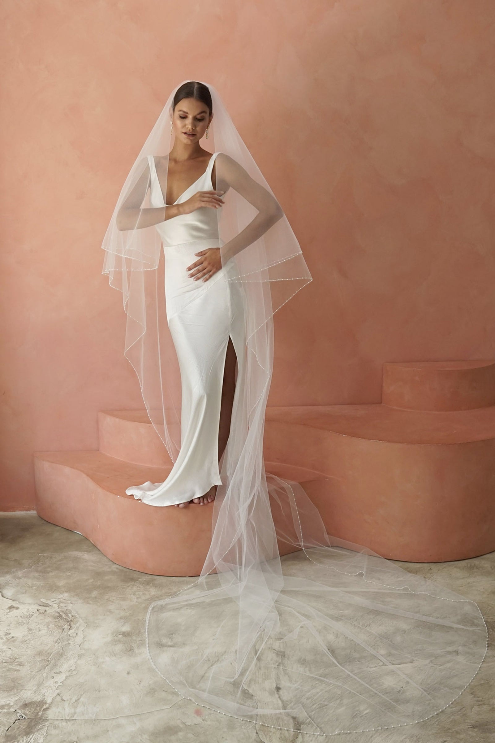 model wears two-tier pearl edge veil, drop veil with pearls on the edges