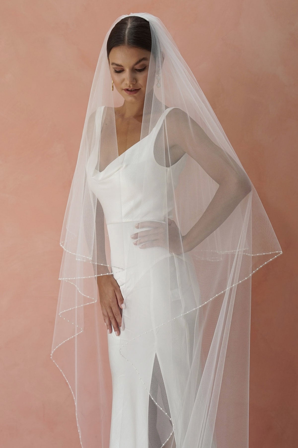 model wears two-tier pearl edge veil, drop veil with pearls on the edges