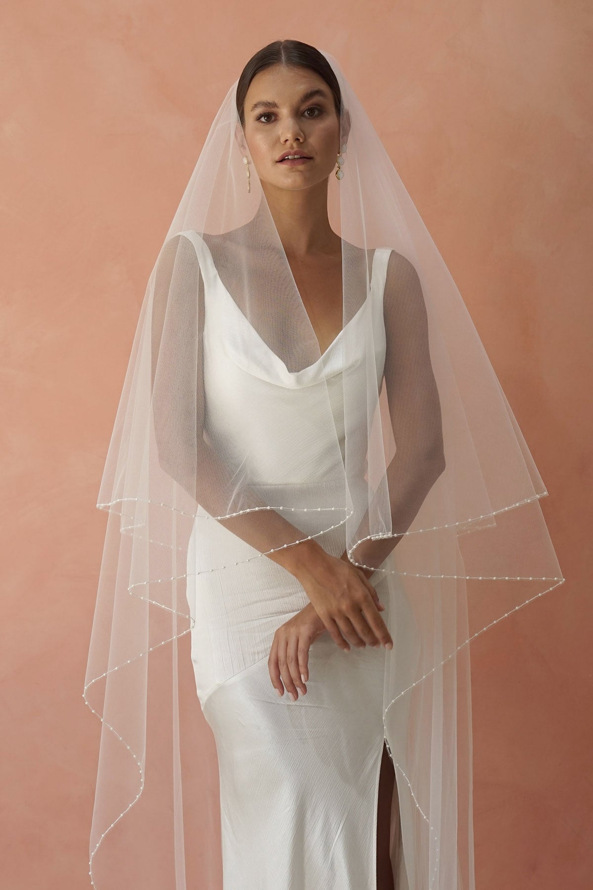 model wears two-tier pearl edge veil, drop veil with pearls on the edges