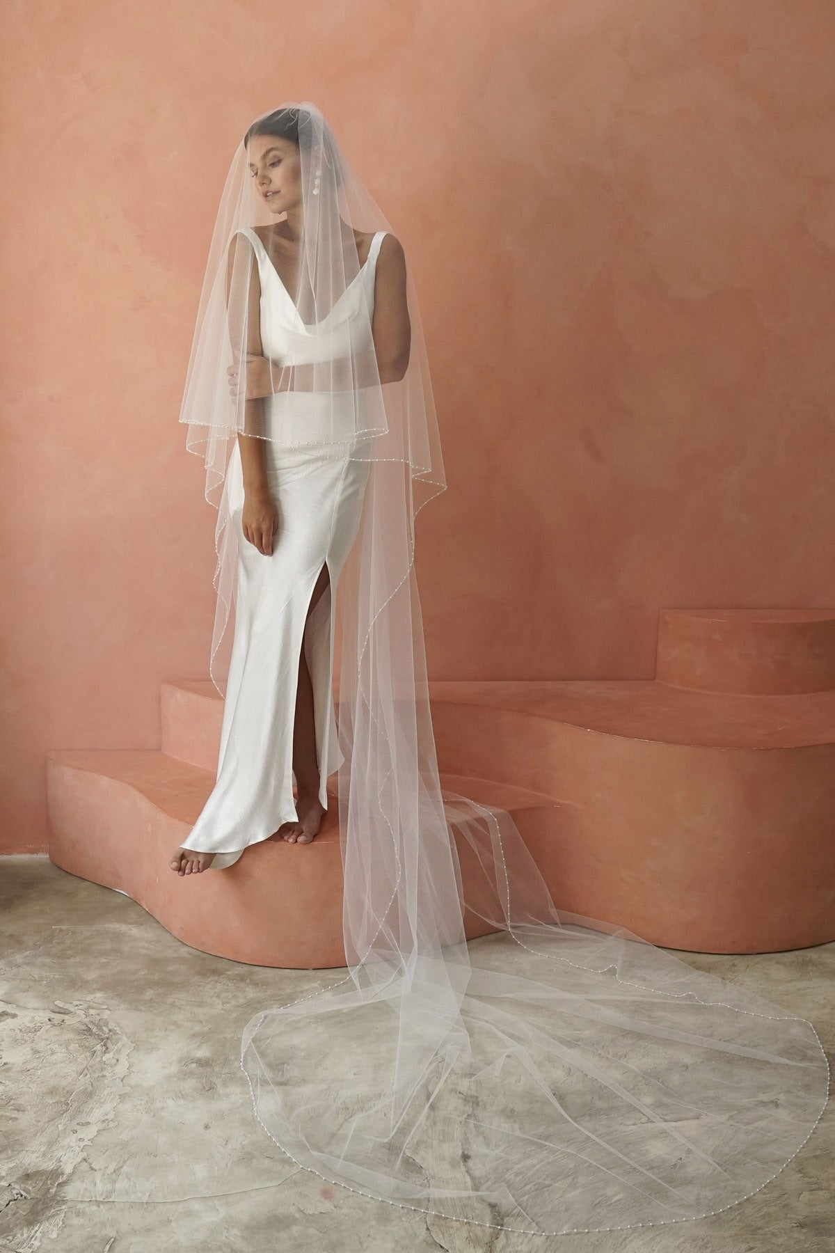 model wears two-tier pearl edge veil, drop veil with pearls on the edges