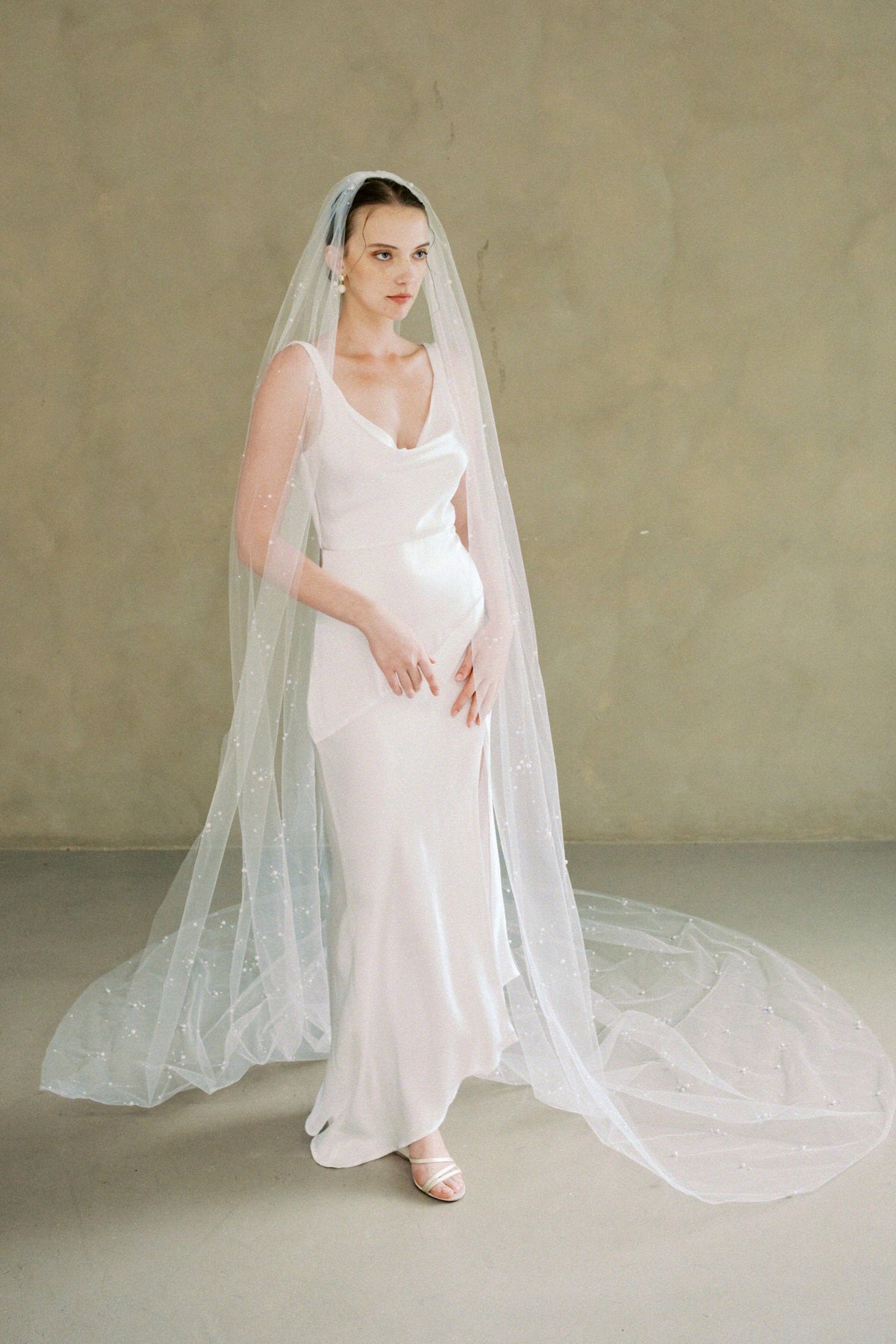 Model wears a one-tier pearl wedding veil made by Madame Tulle bridal