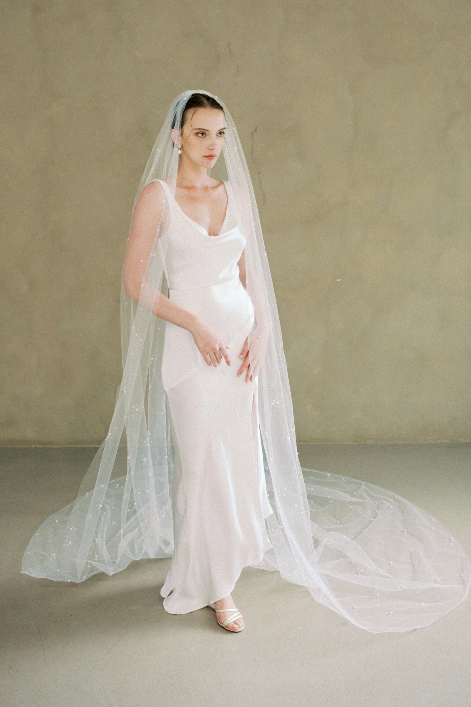 Model wears a one tier pearl wedding veil made by Madame Tulle bridal