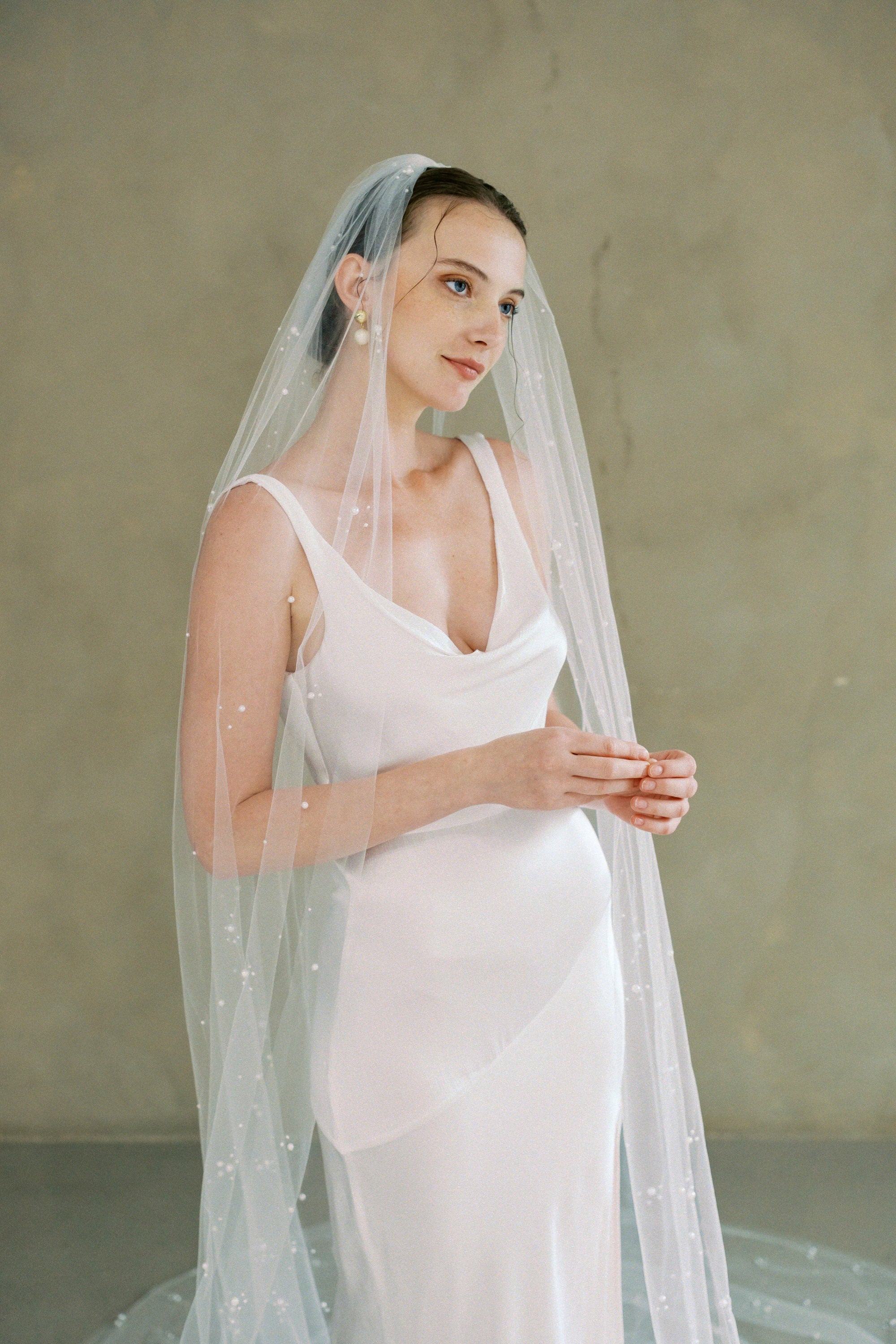 Model wears a one tier pearl wedding veil made by Madame Tulle bridal