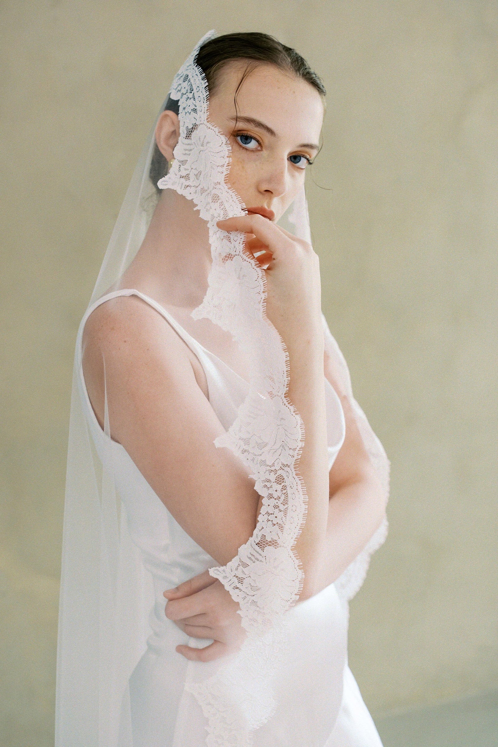 model wears one-tier lace Mantilla veil