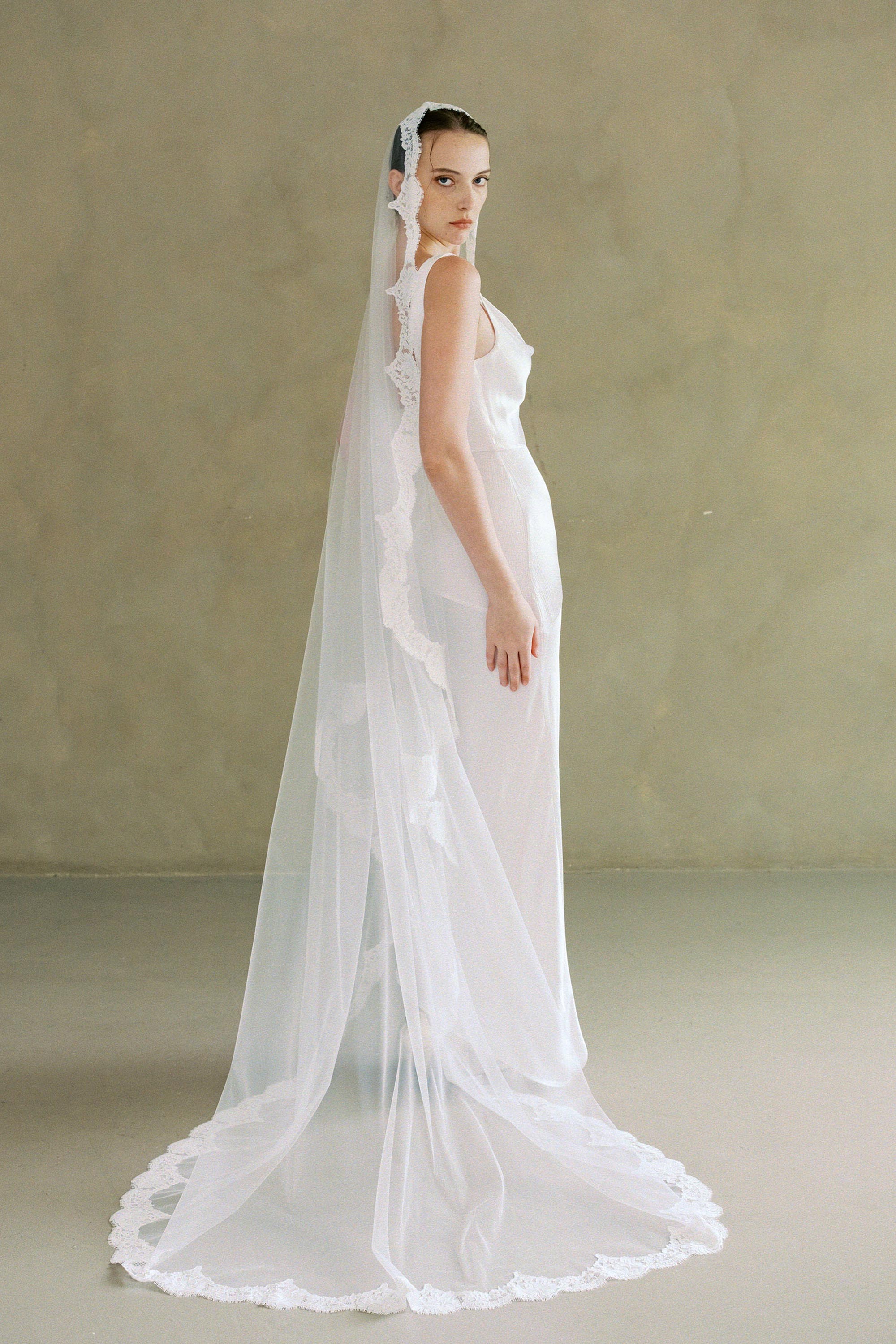 model wears one-tier lace Mantilla veil