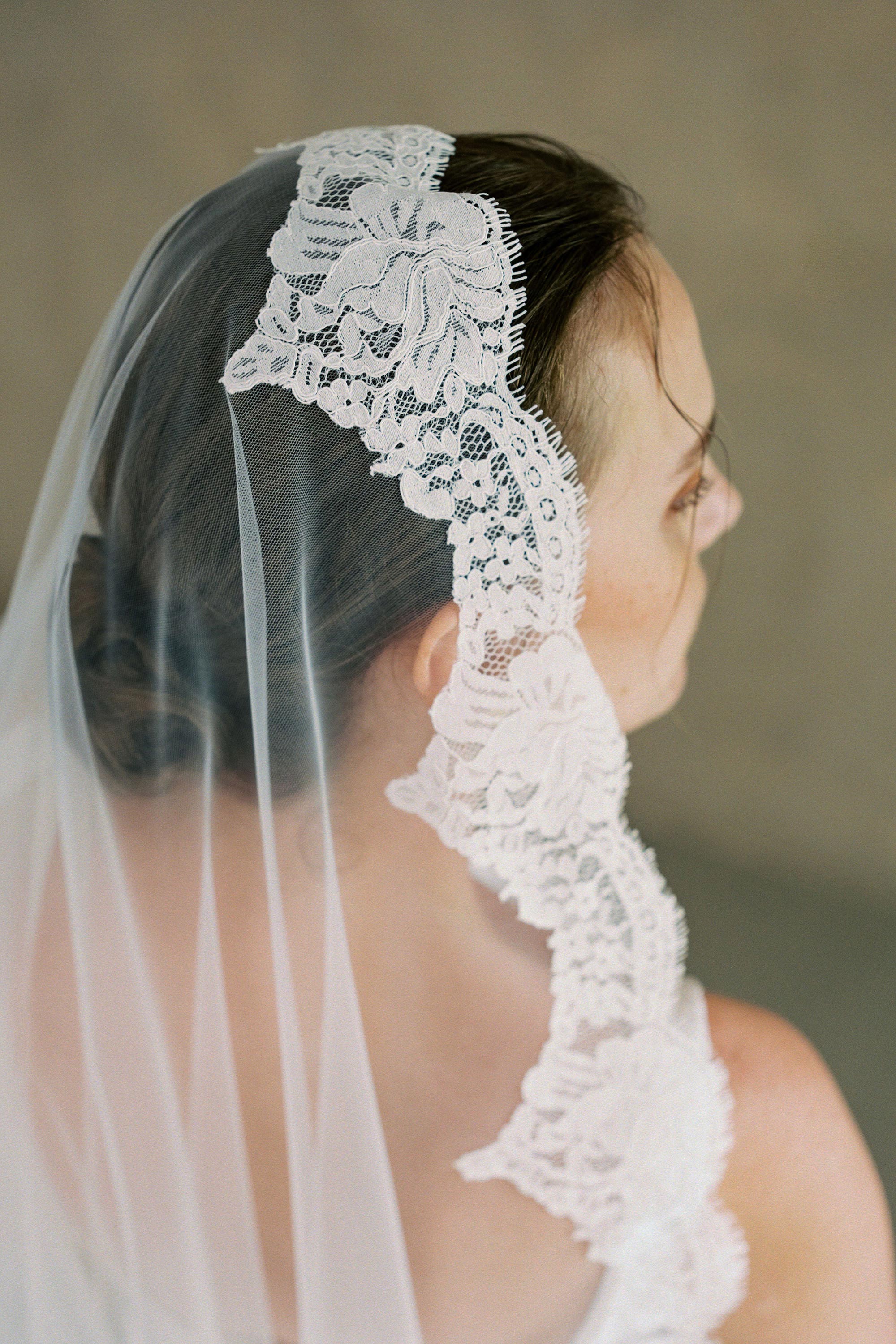 model wears one-tier lace Mantilla veil