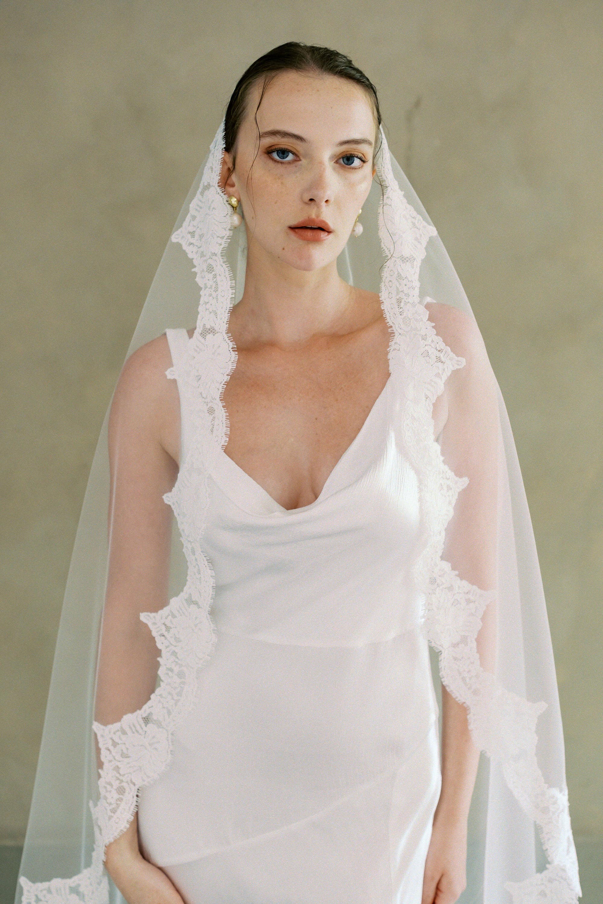 model wears one-tier lace Mantilla veil