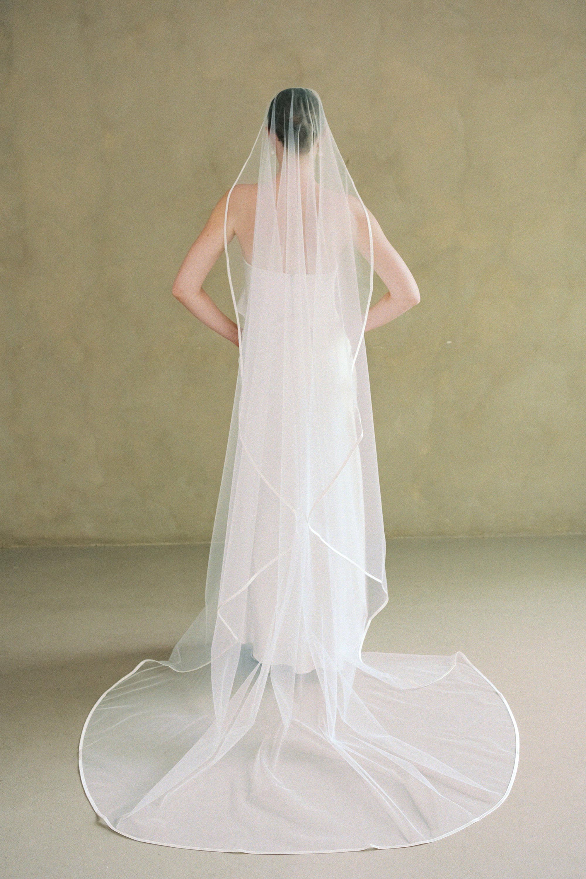 models wears one-tier satin edge mantilla wedding veil