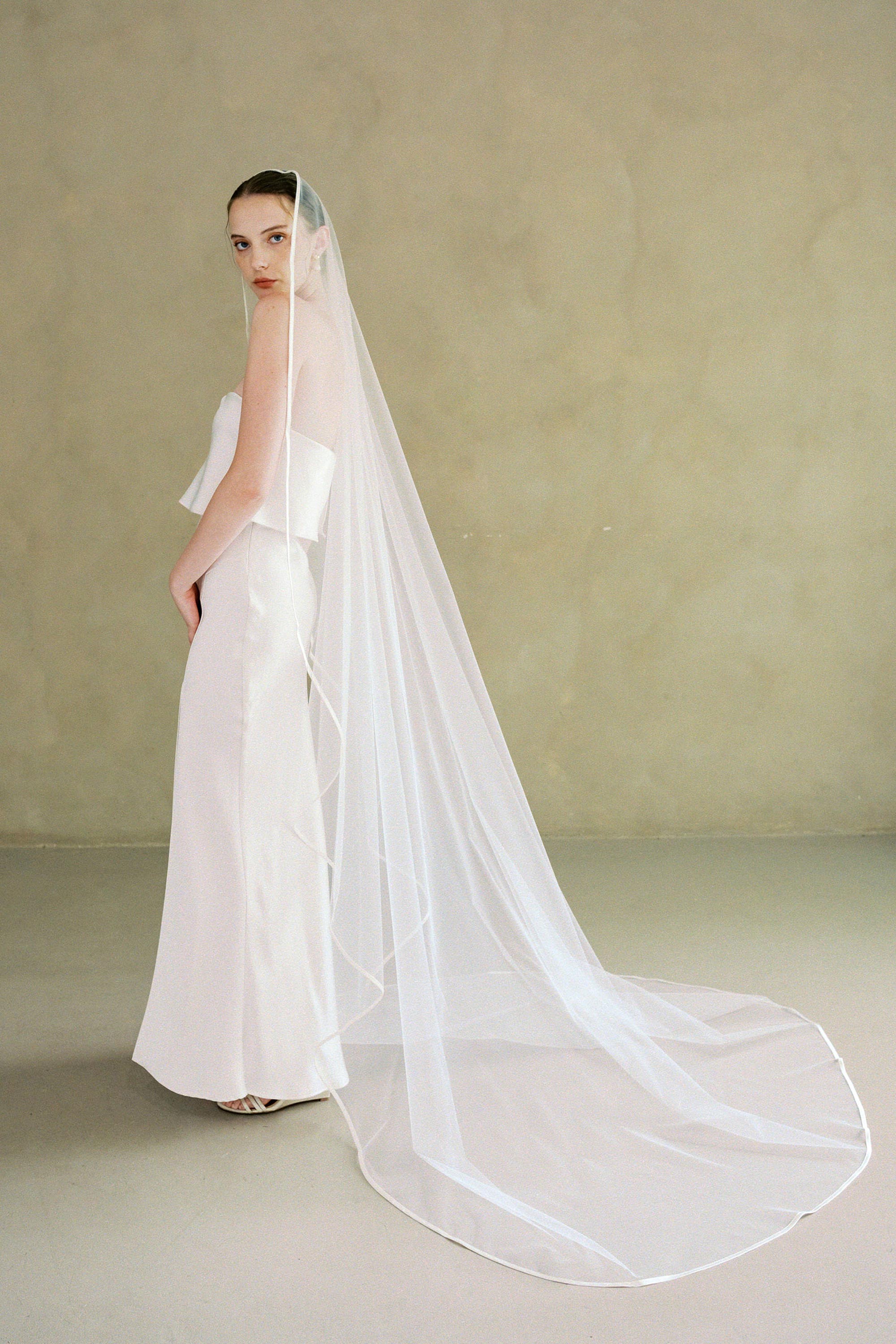models wears one-tier satin edge wedding veil