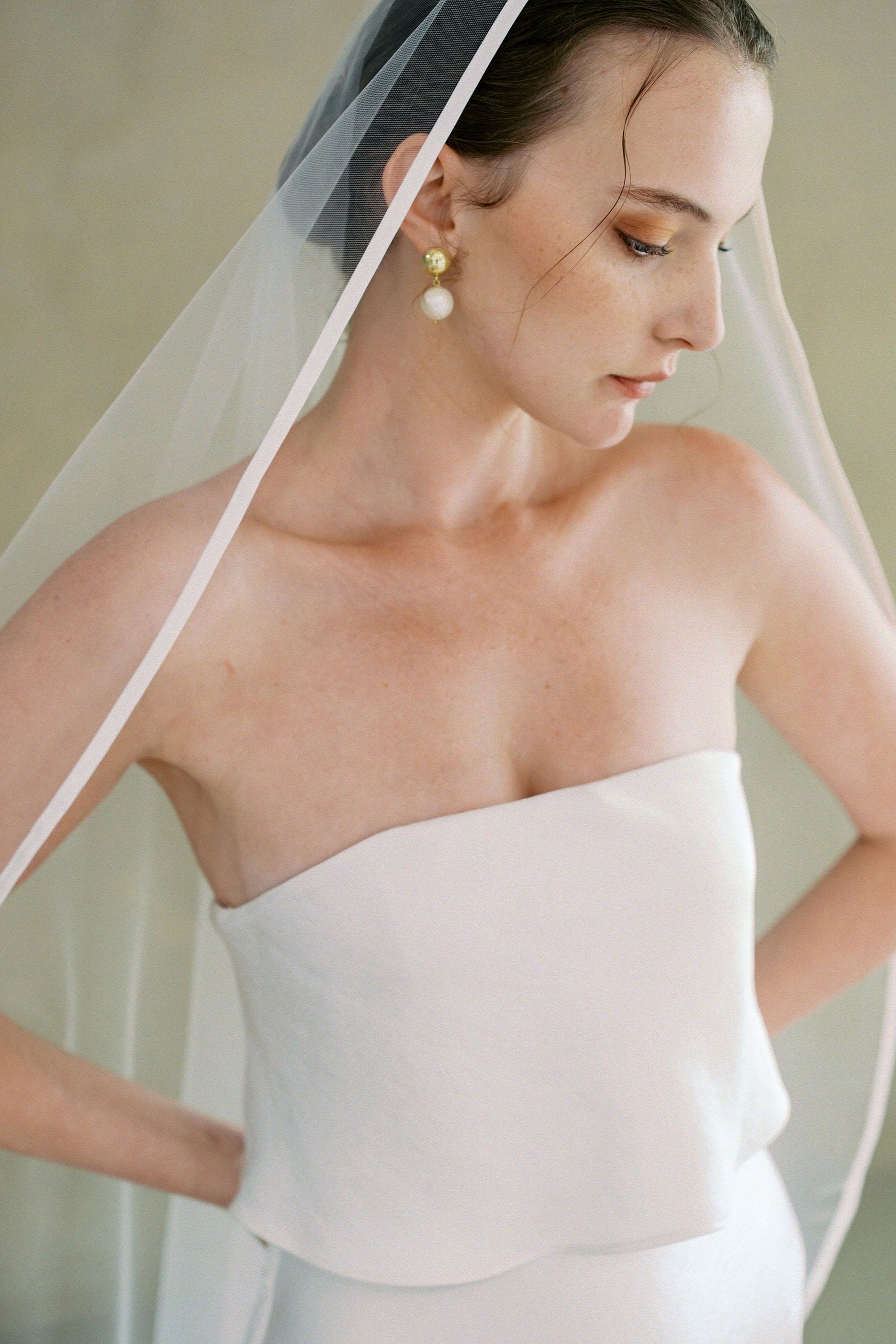 models wears one-tier satin edge wedding veil