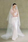 model wears a drop veil glitter wedding veil