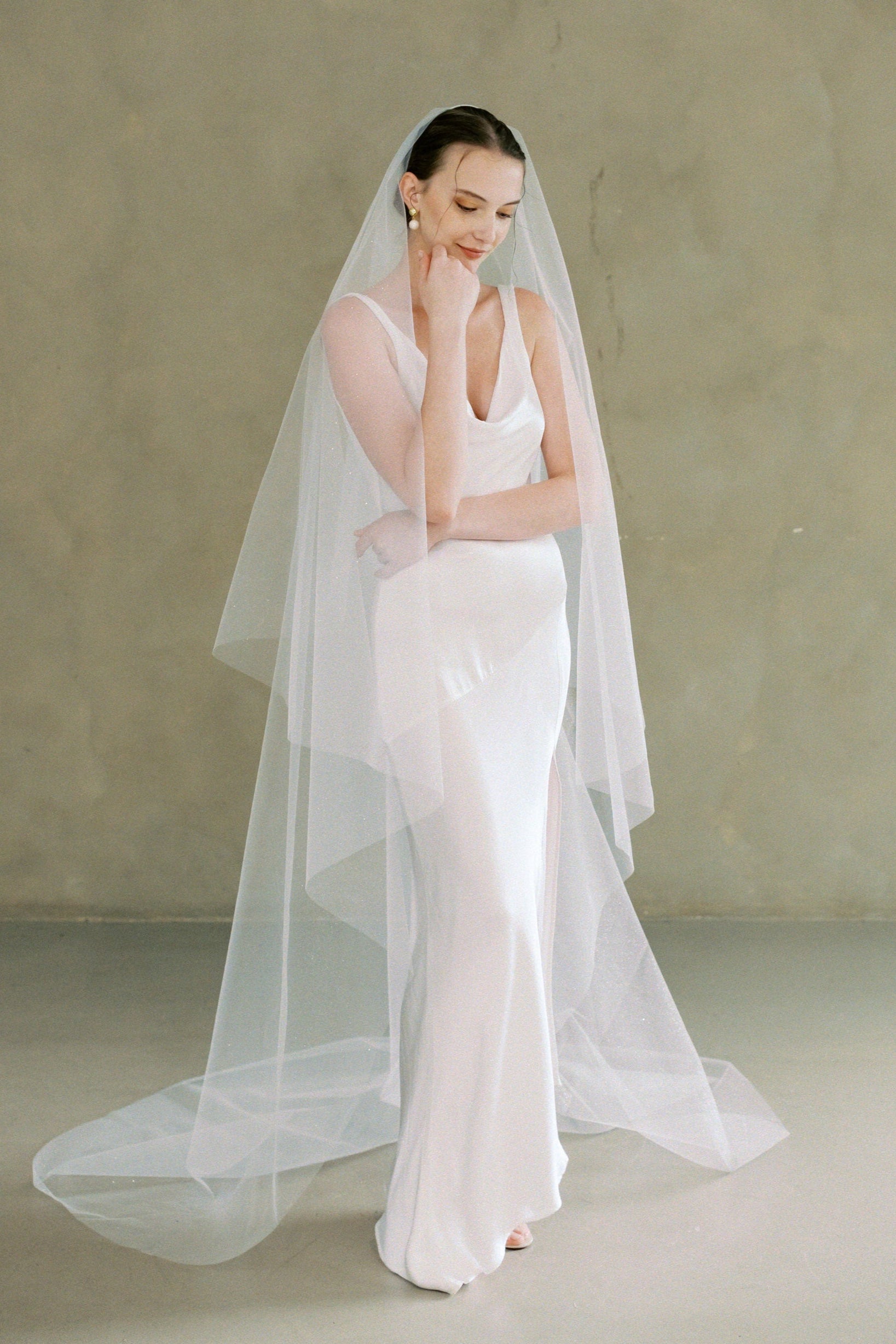 model wears a drop veil glitter wedding veil