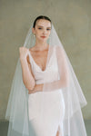 model wears a drop veil glitter wedding veil