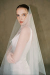 model wears a drop veil glitter wedding veil