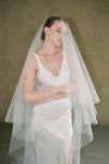 model wears a drop veil glitter wedding veil