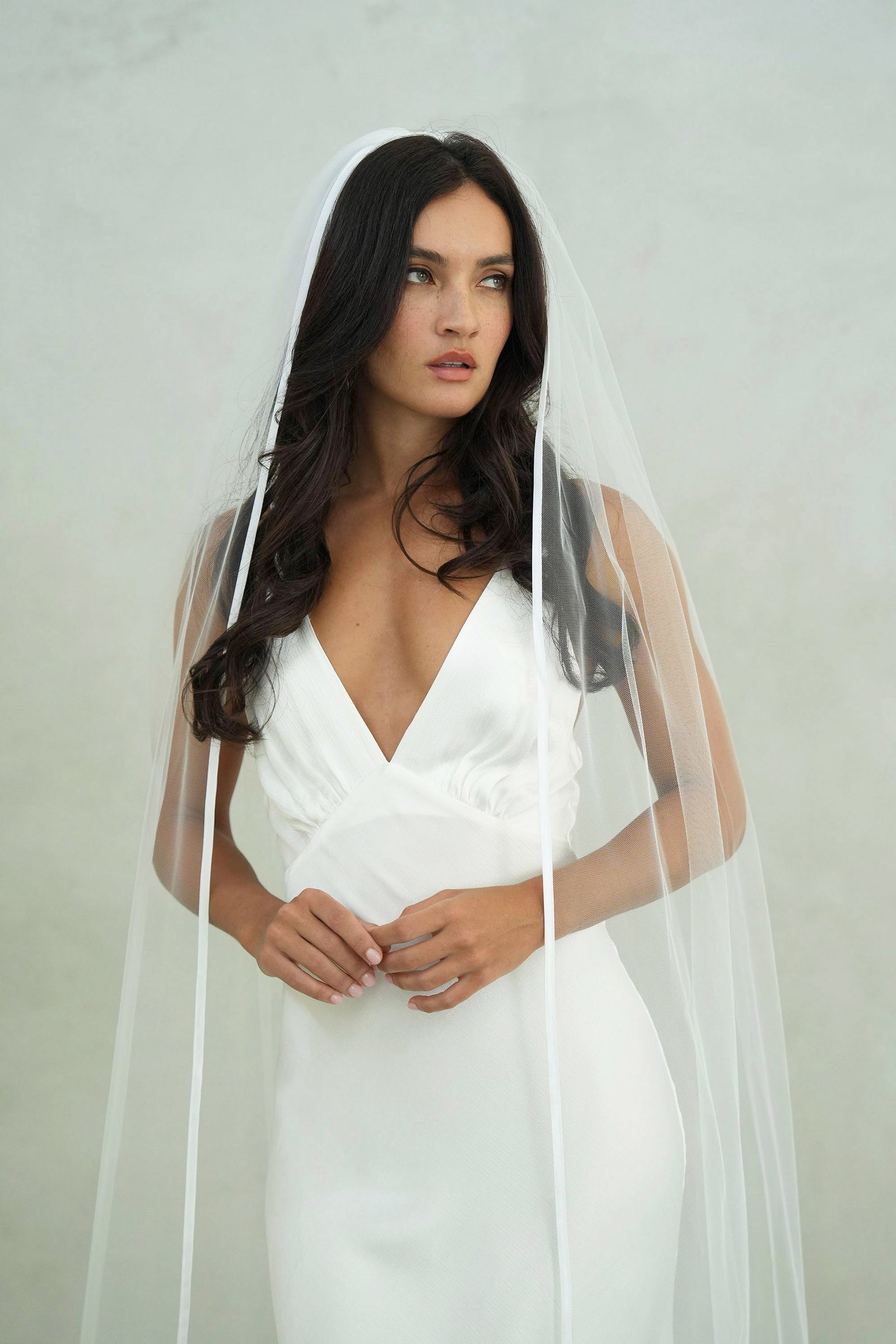 model wears one-tear wedding veil, satin edge veil 