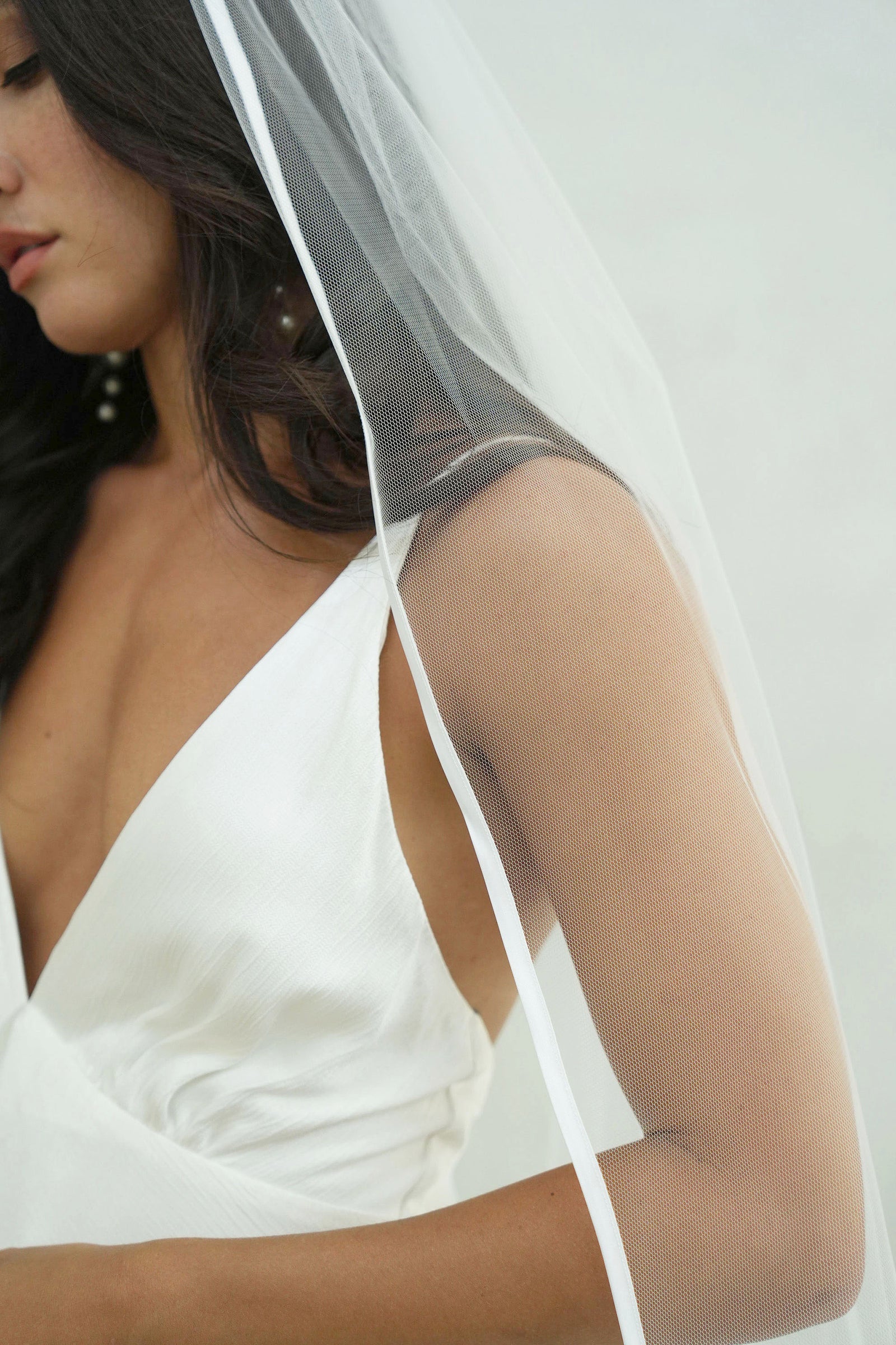 model wears one-tear wedding veil, satin edge veil 