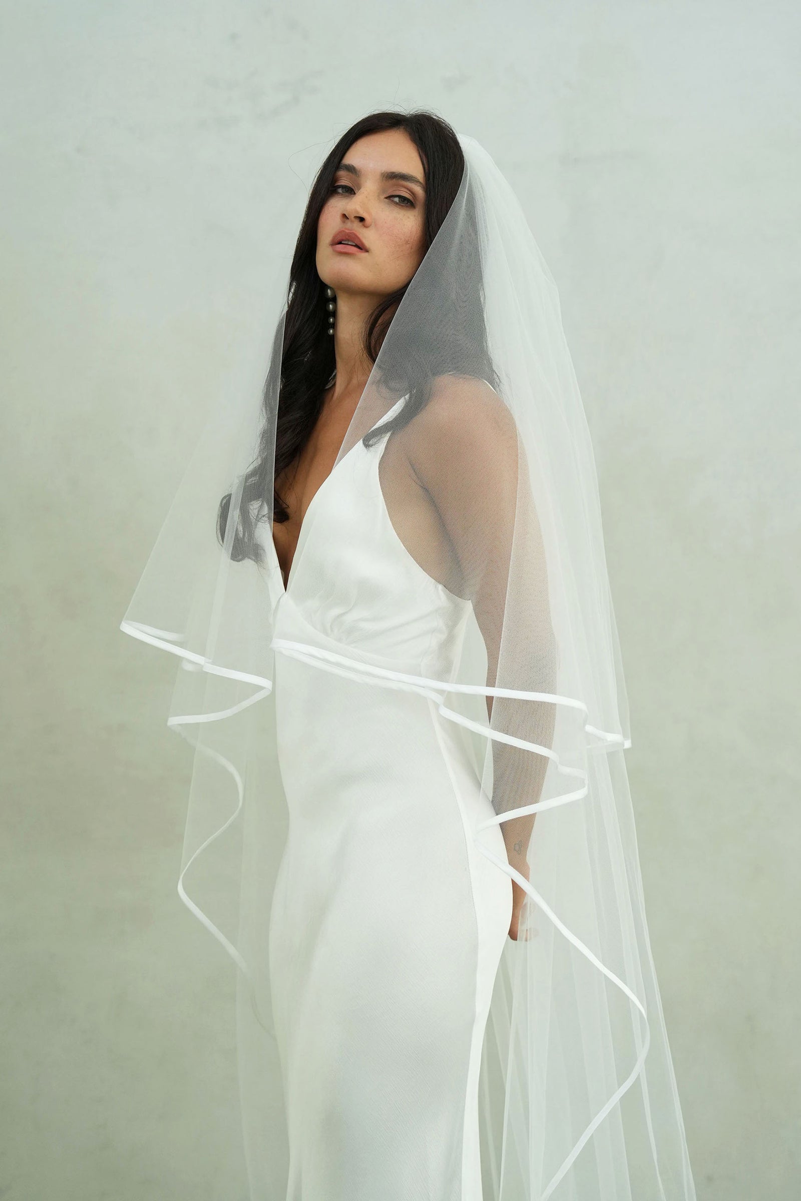 model wears two-tear wedding veil, satin edge veil 