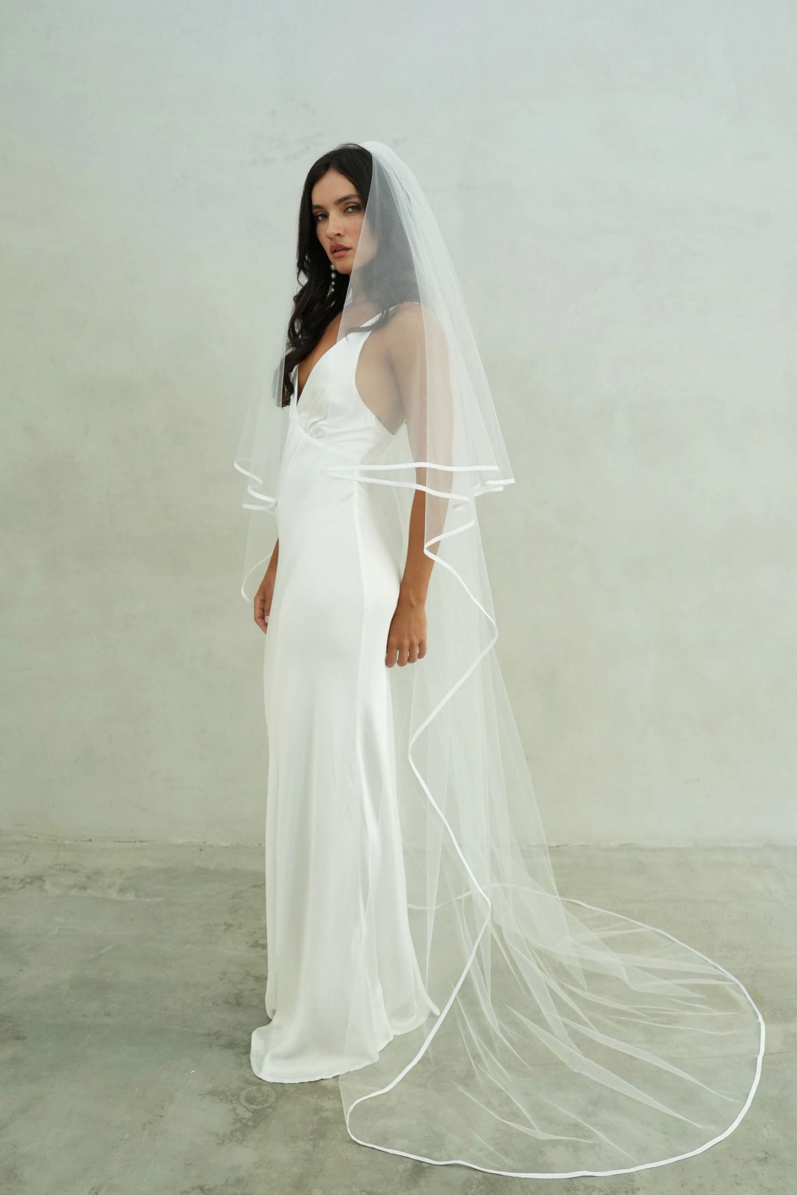 model wears two-tear wedding veil, satin edge veil 