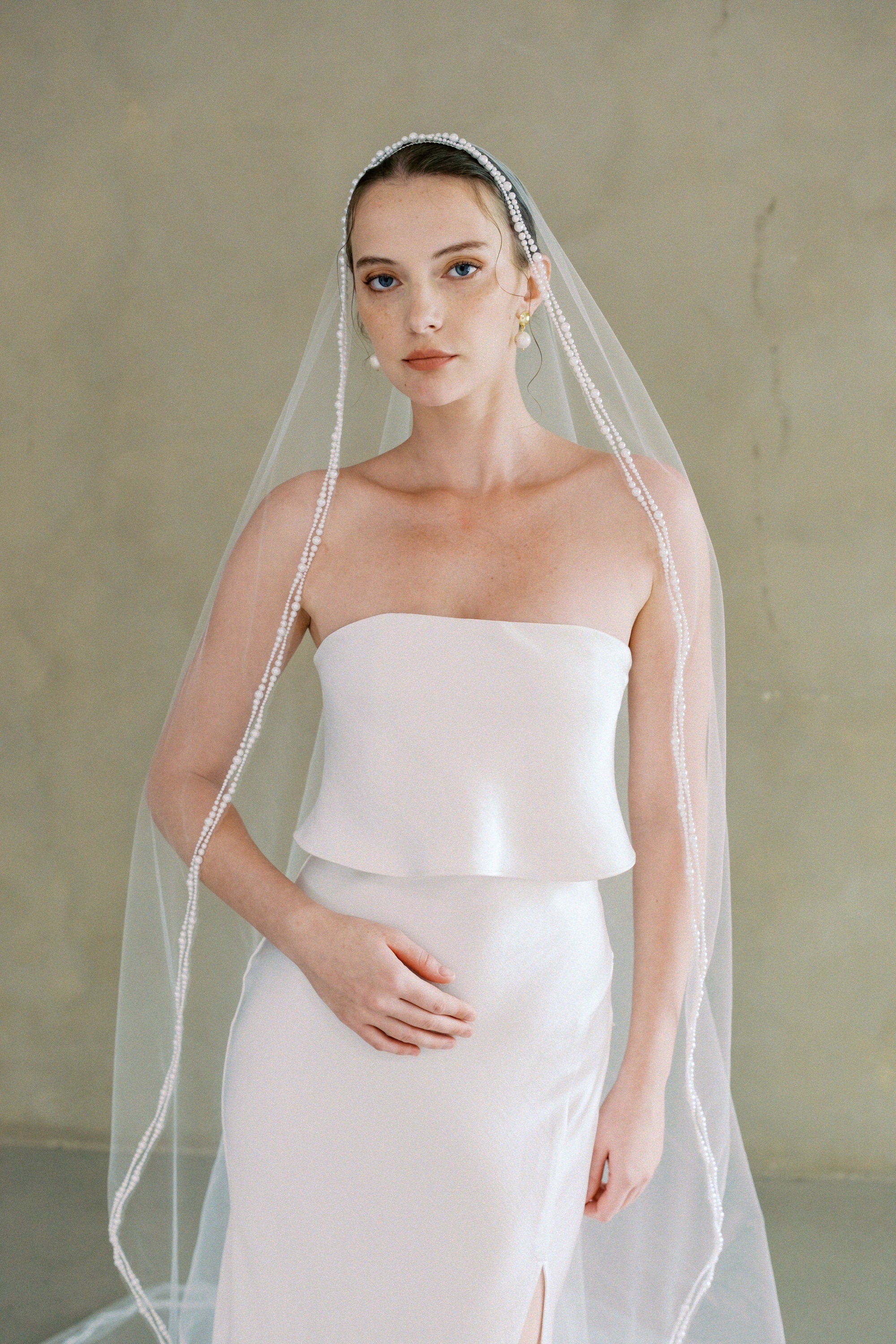 model wears a one-tier mantilla pearl edge veil
