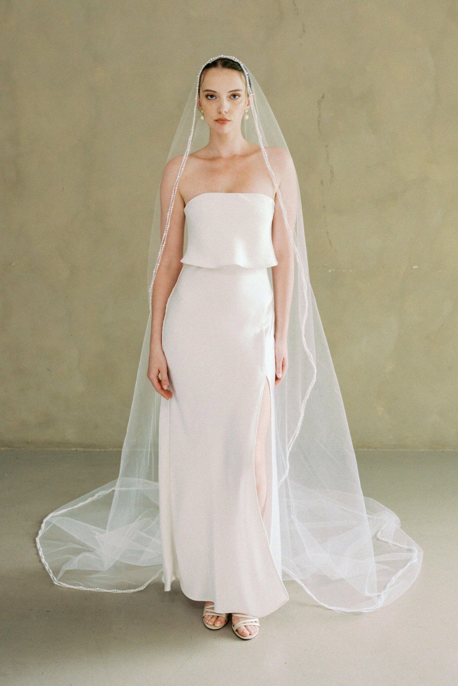 model wears a one-tier mantilla pearl edge veil