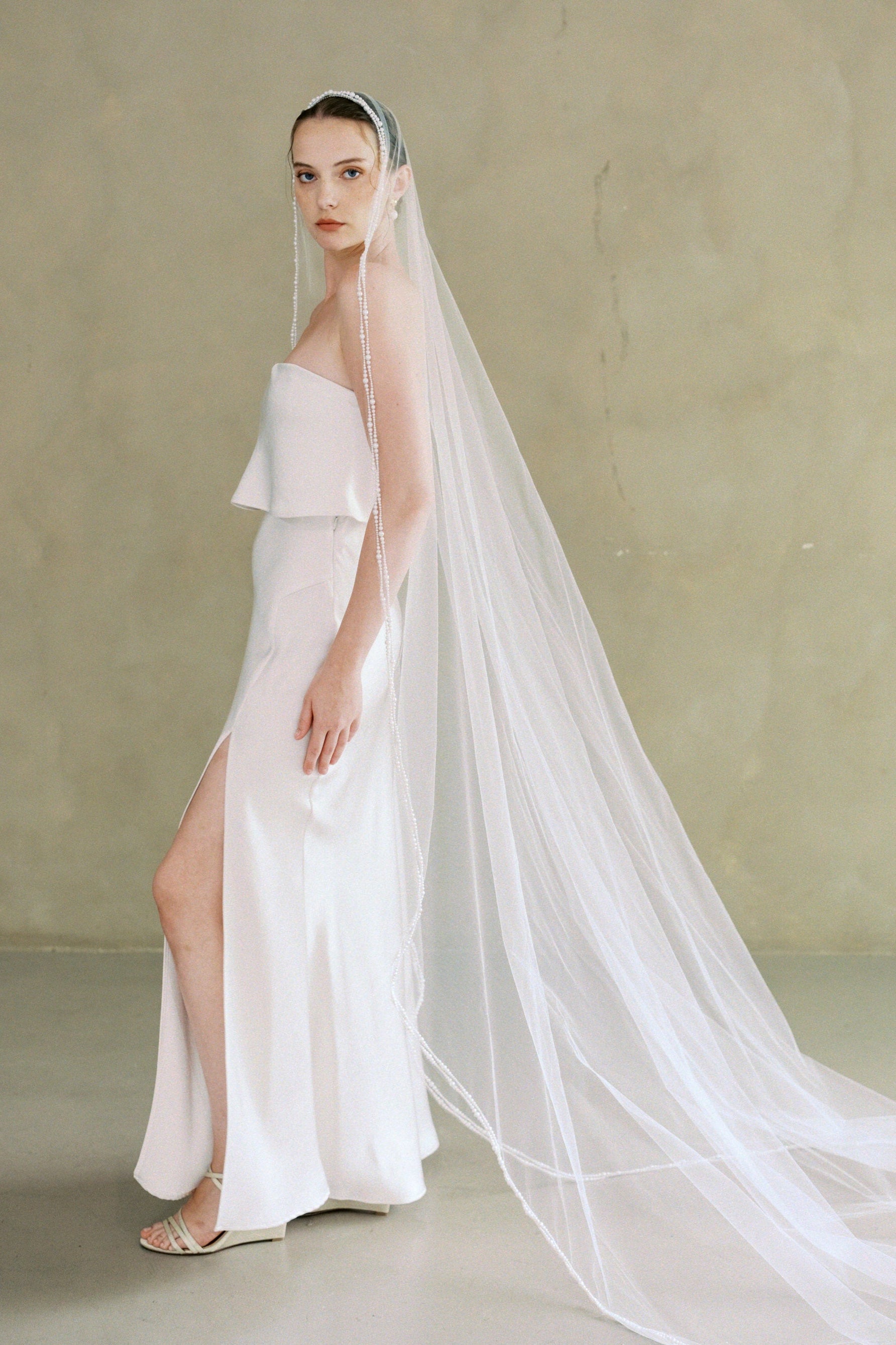 model wears a one-tier mantilla pearl edge veil