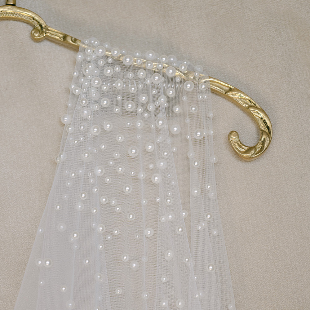 Close up of bridal veil featuring pearl embellishment