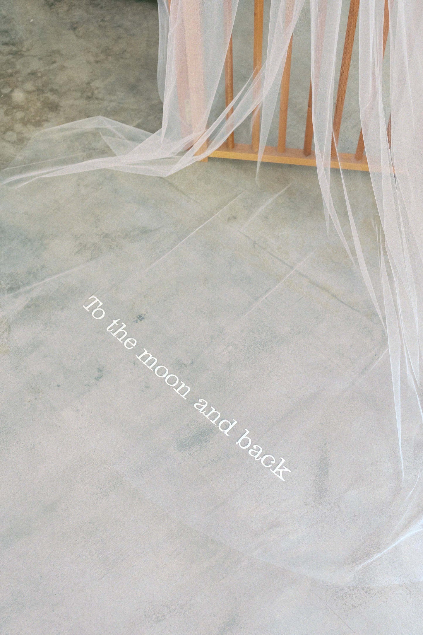 Romantic message is custom embroidered on train of long wedding veil by Madame Tulle