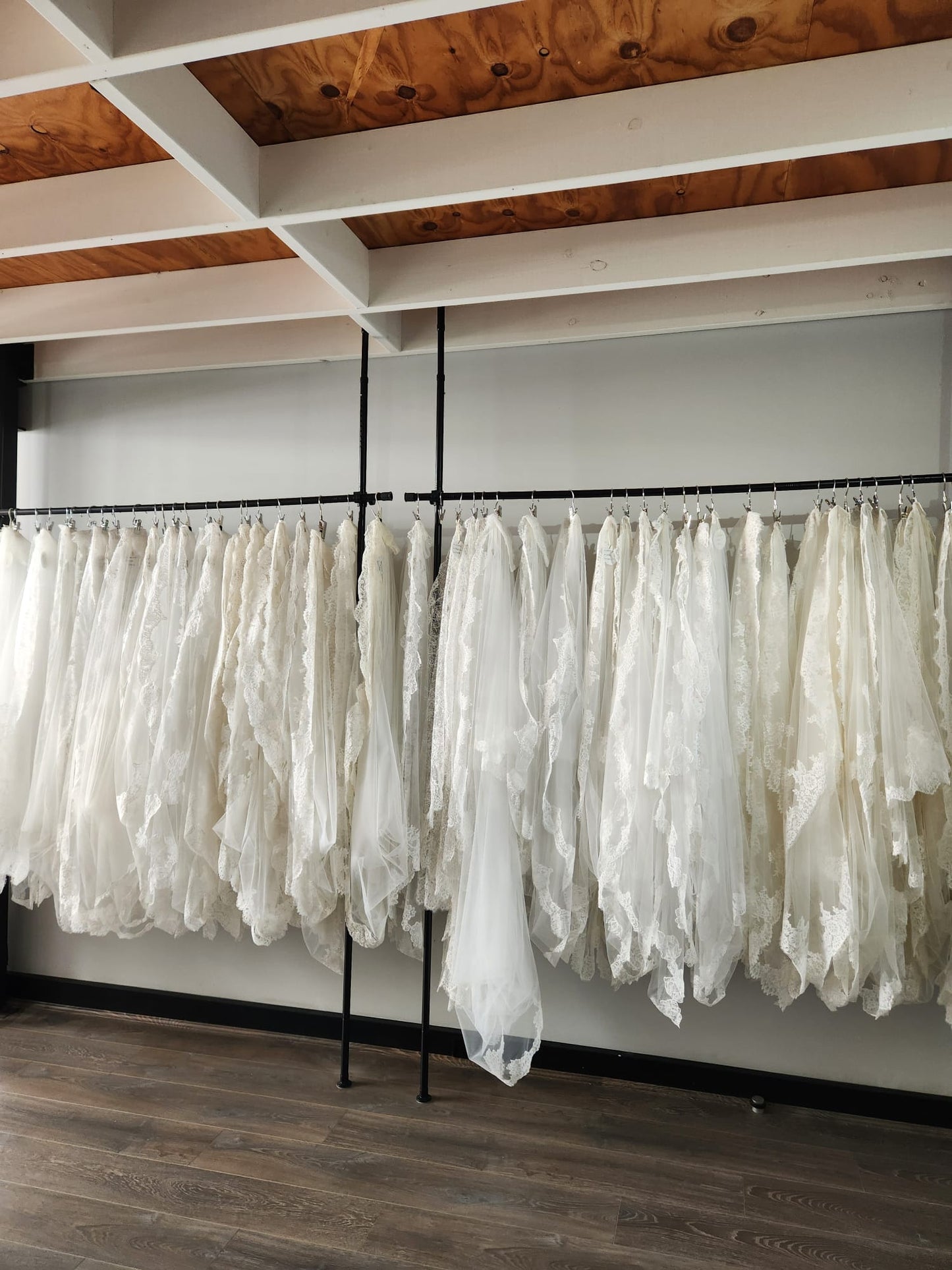 Studio shot for Madame Tulle Bridal showing veil collection hanging on garment racks