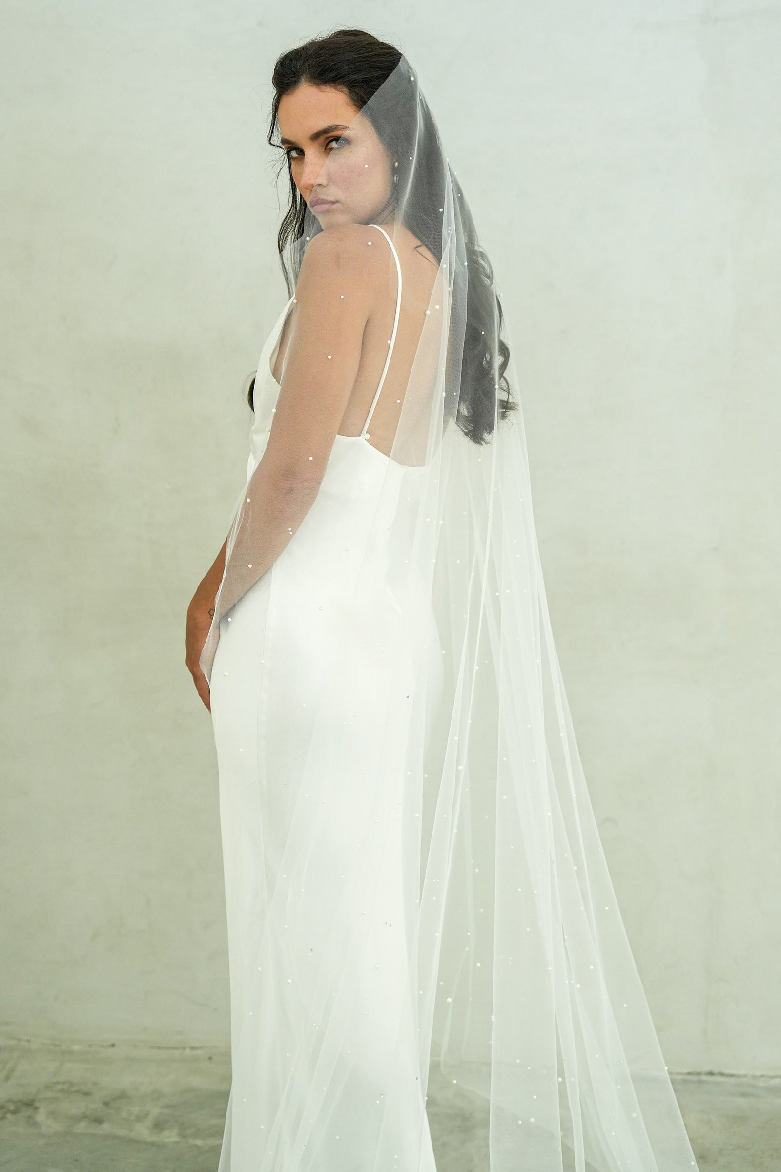 model wears a one-tier a pearl and crystal wedding veil