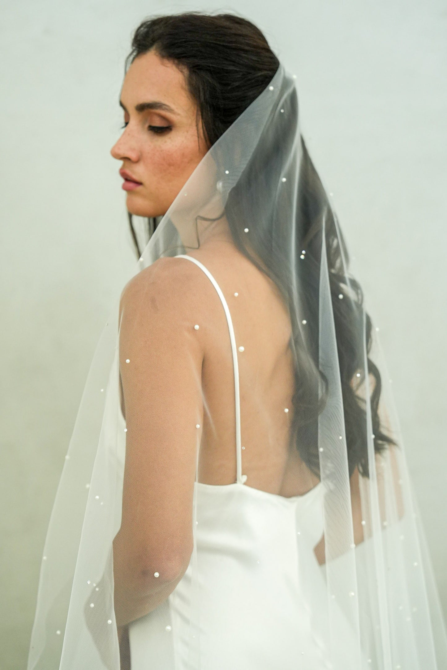 model wears a one-tier a pearl and crystal wedding veil