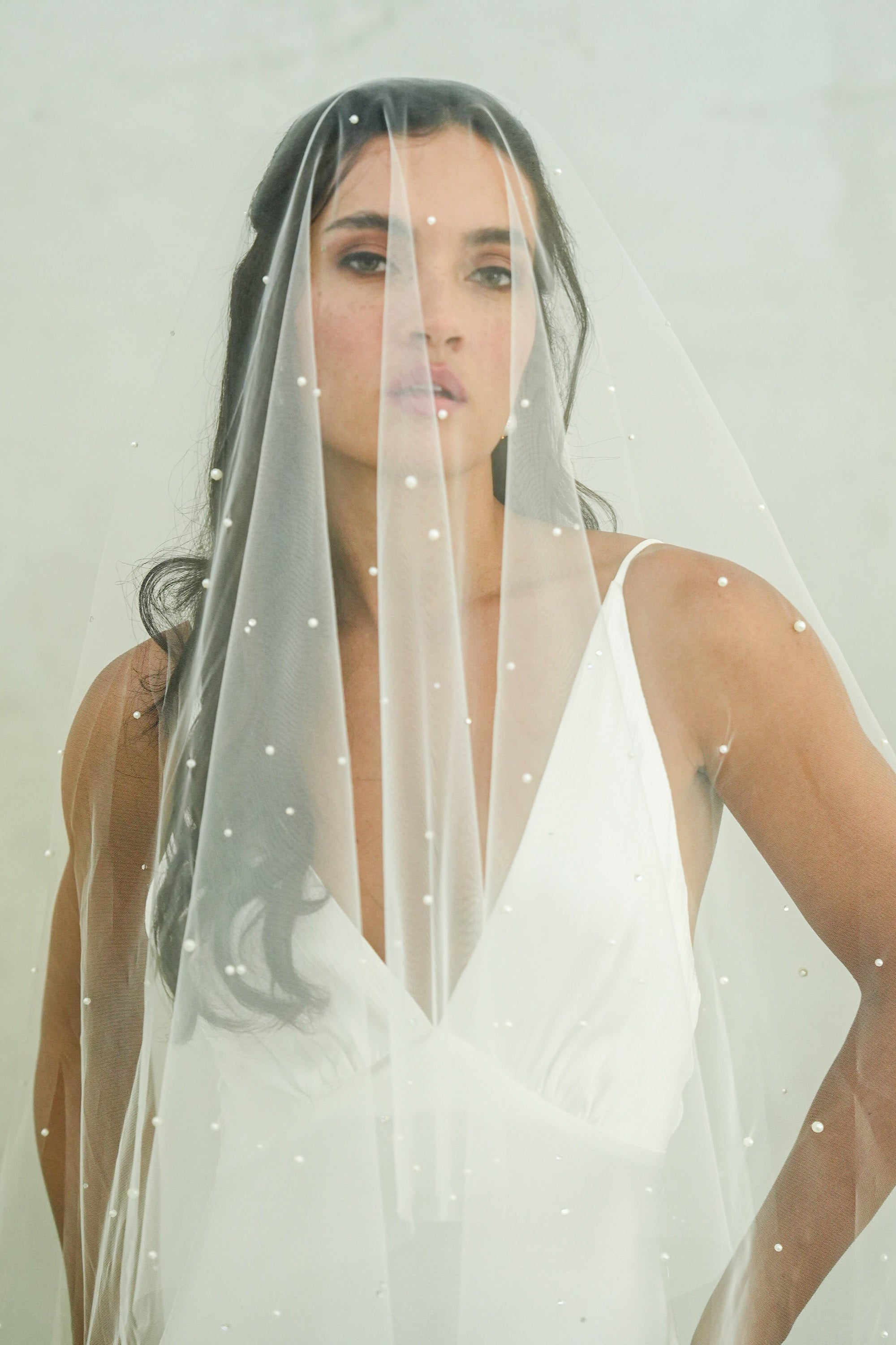 model wears a drop pearl and crystal wedding veil
